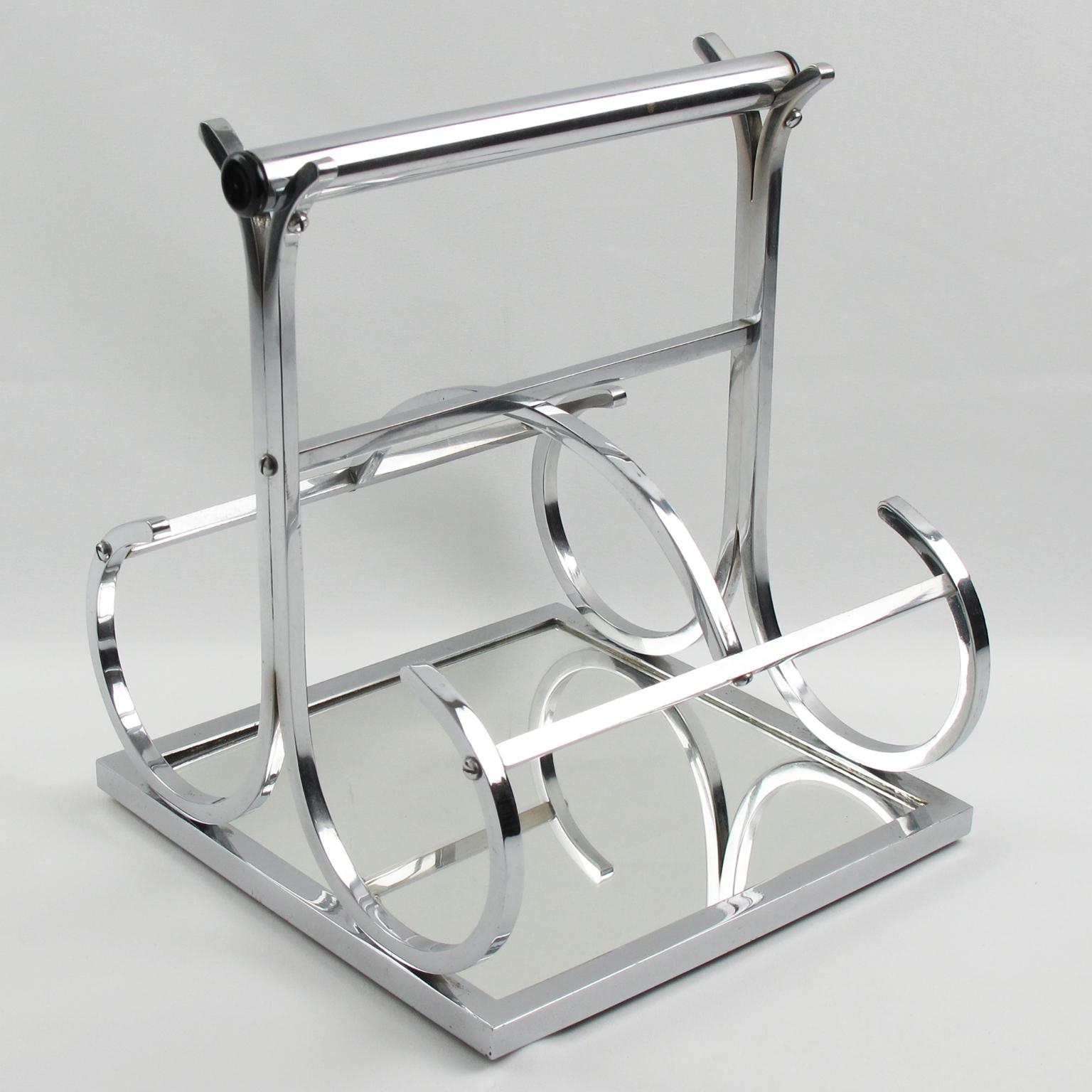 French designer Jacques Adnet (1901 - 1984) designed this elegant Art Deco modernist wine bottle carrier or holder in the 1930s. The barware piece boasts a streamlined sculptural geometric shape with chrome-plated metal, mirror, and black Bakelite.