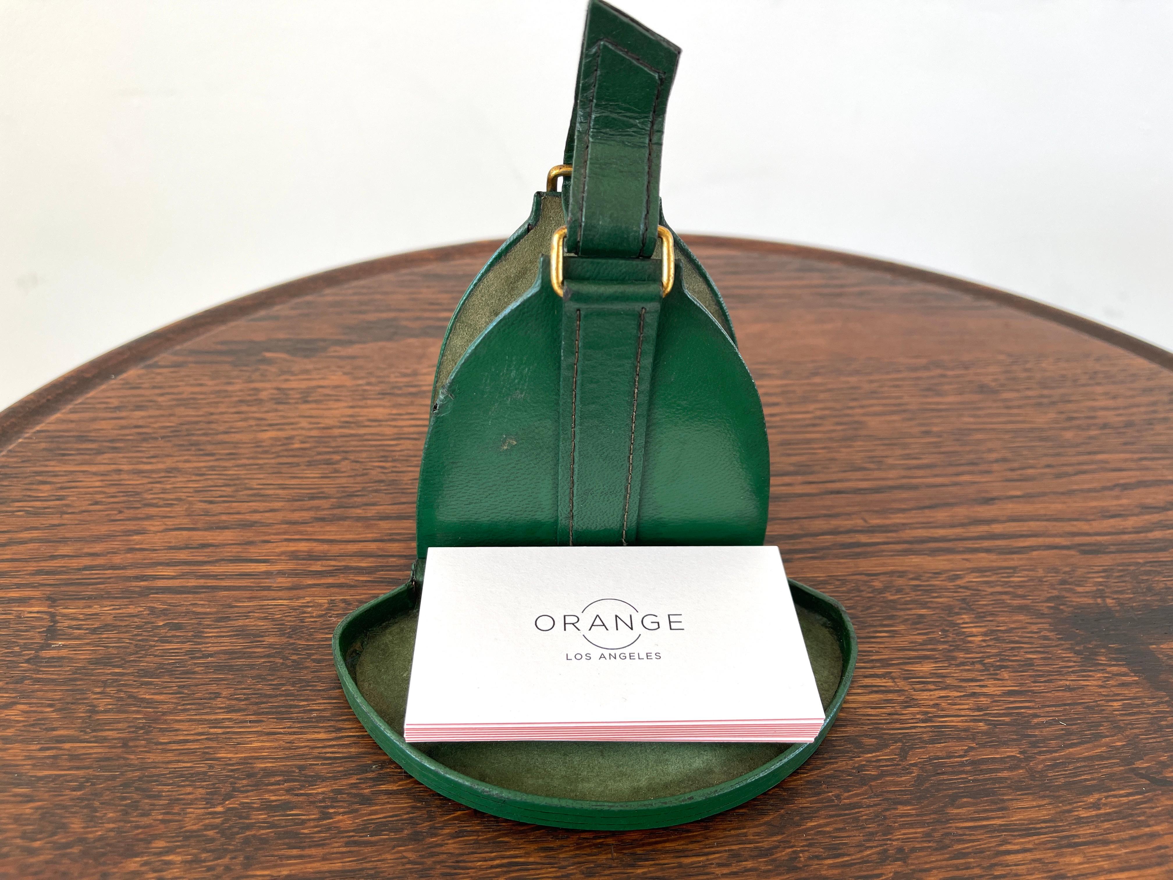 Handsome green leather catchall attributed to Jacques Adnet with brass buckle. 