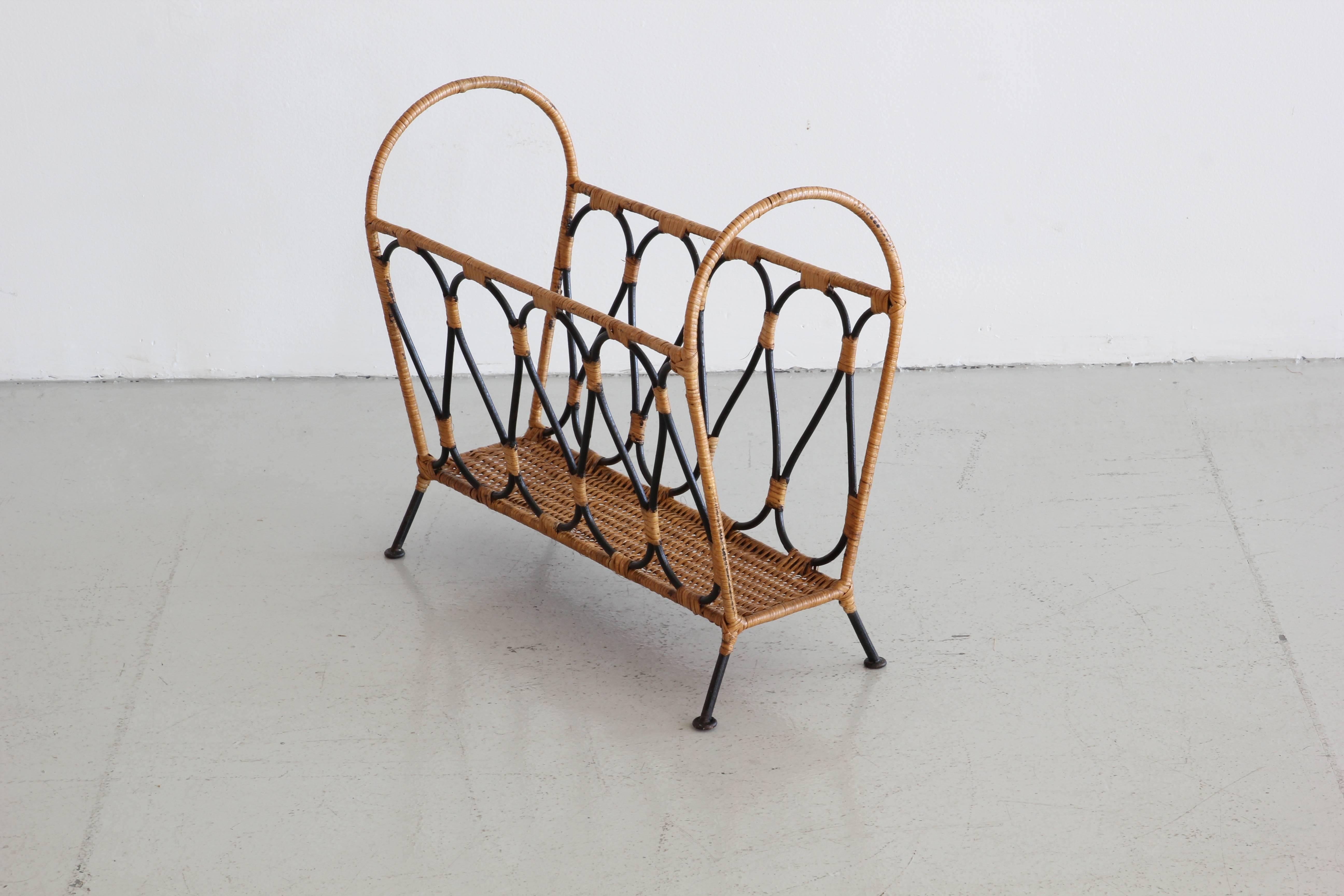 Fantastic magazine rack attributed to Jacques Adnet with bent iron and wicker.