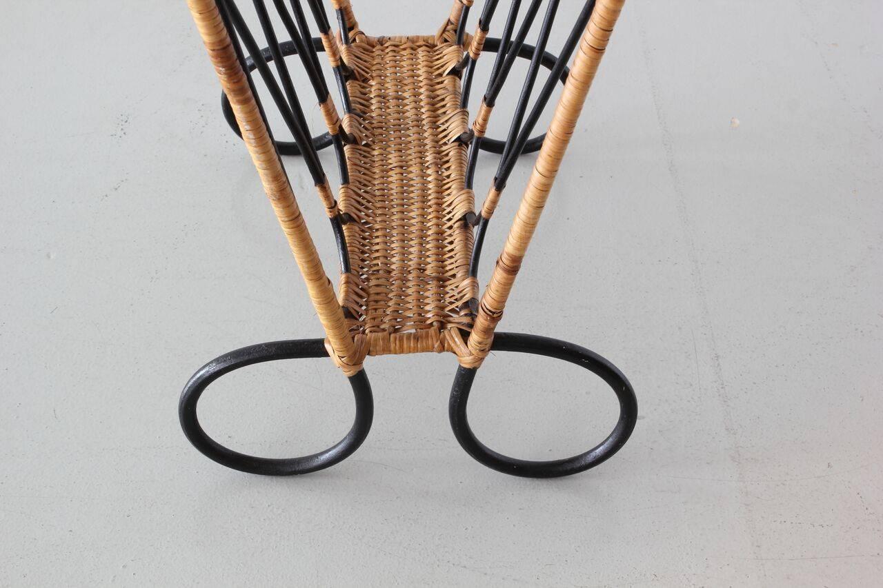 Rare French wicker magazine table and magazine holder with iron loop legs.
Wicker and rattan, circa 1950.