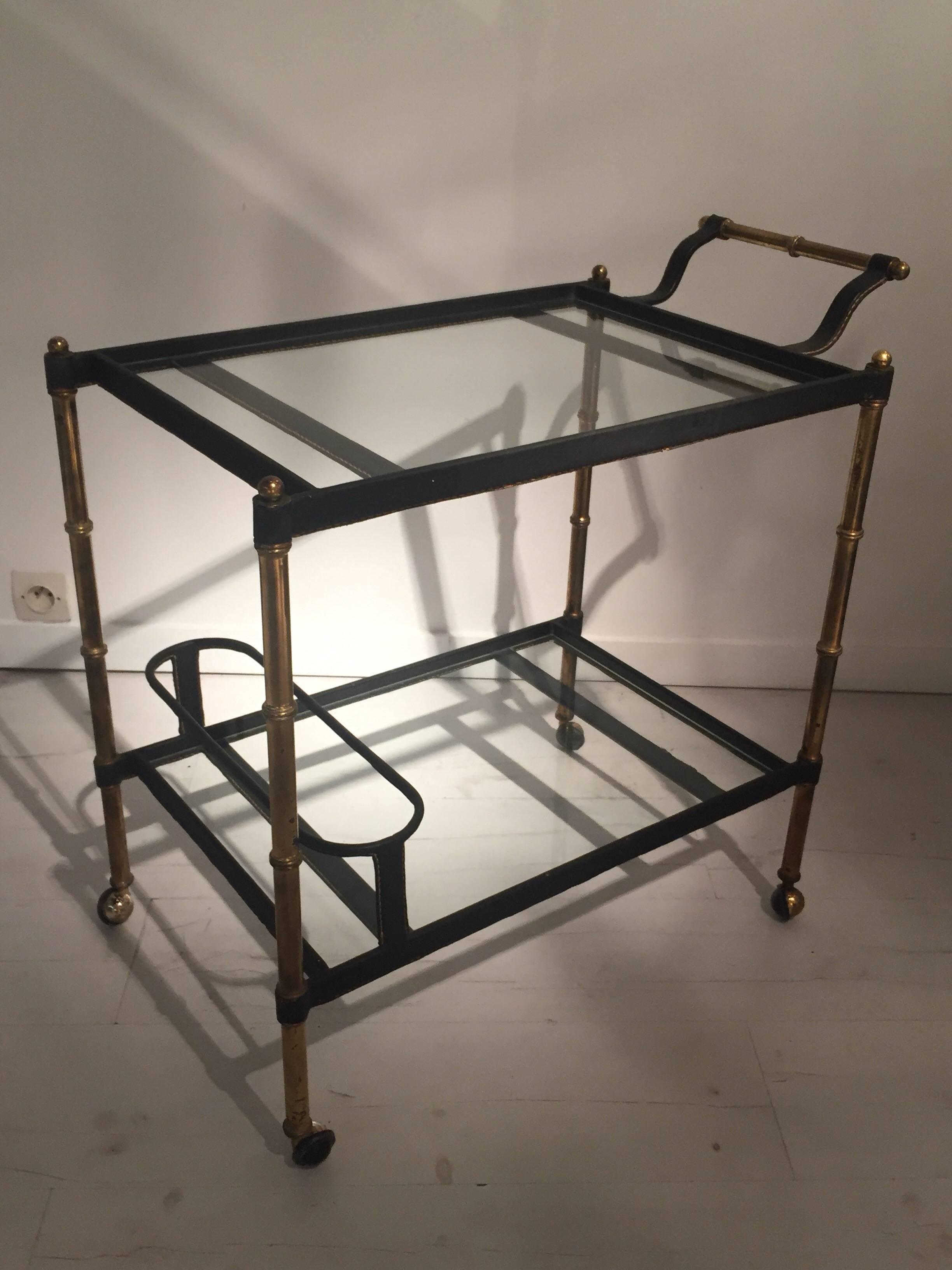 Jacques Adnet bar cart in brass and black stitched leather
Great vintage condition.