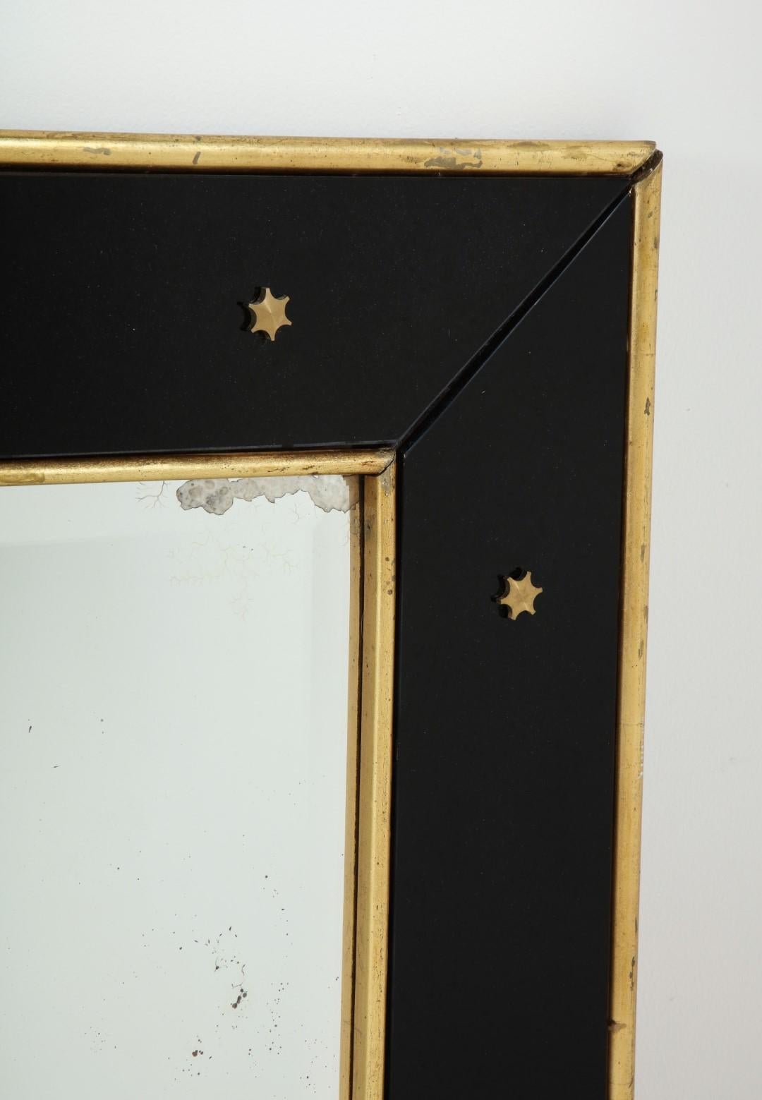 Mid-Century Modern Jacques Adnet Black Glass and Gold Leaf Wall Mirror with Star Detail, circa 1940