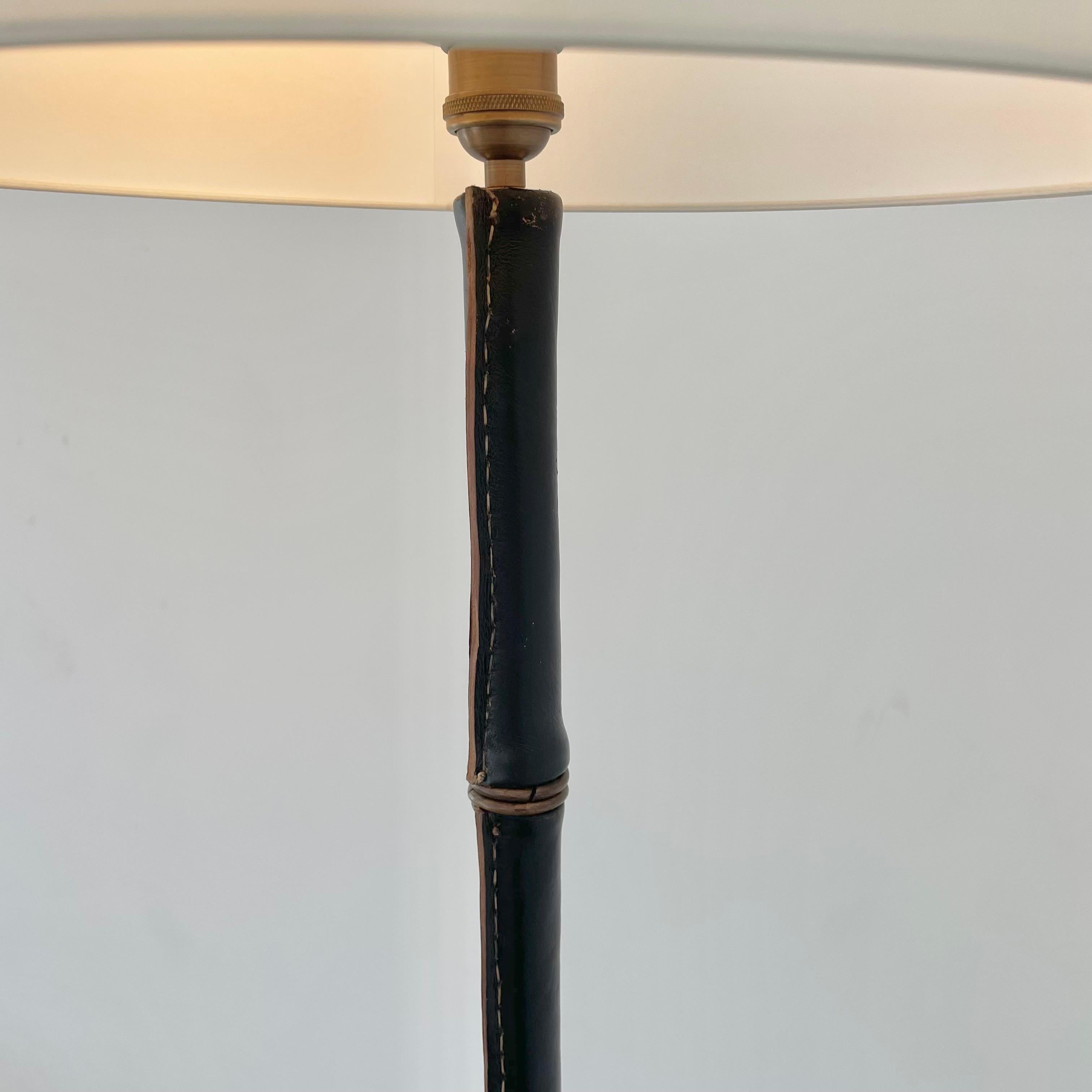 French Jacques Adnet Black Leather and Brass Tripod Floor Lamp, 1950s France