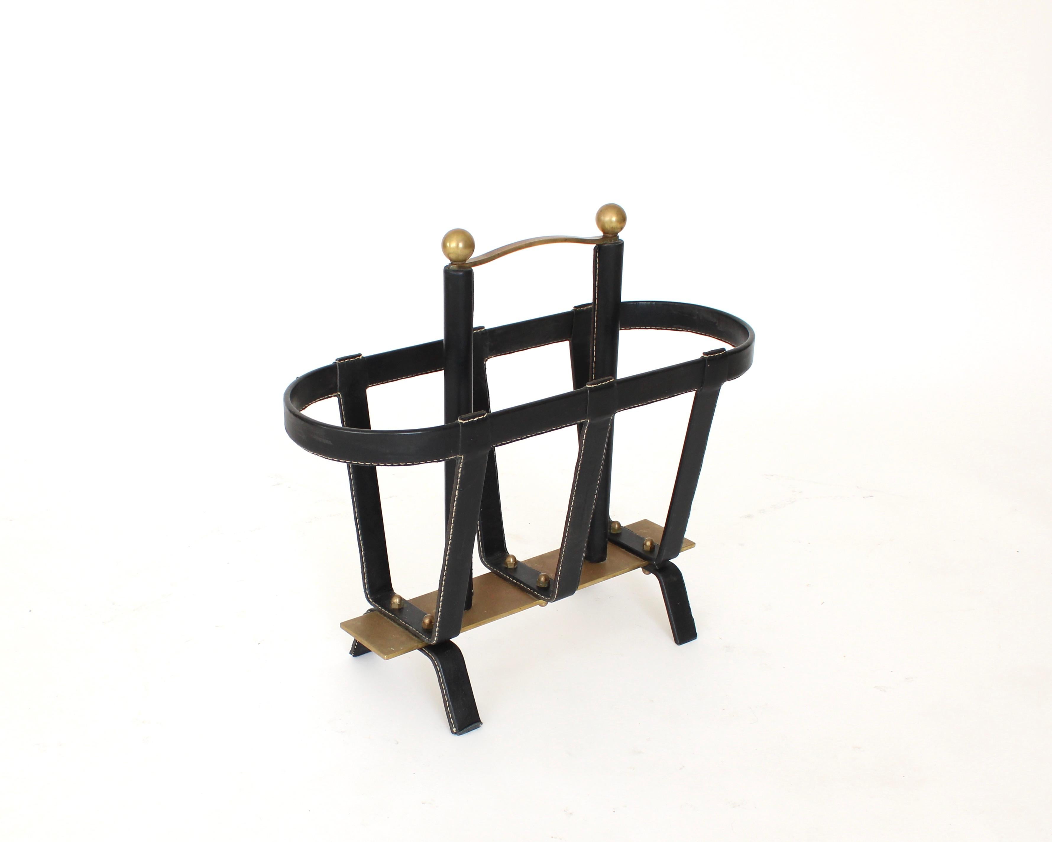 Jacques Adnet French black leather and bronze magazine holder. 
This example is of the highest quality of Adnet and most certainly was not. Mass produced as other of Adnet magazine holders. The bronze handle and decorative balls at the top of the