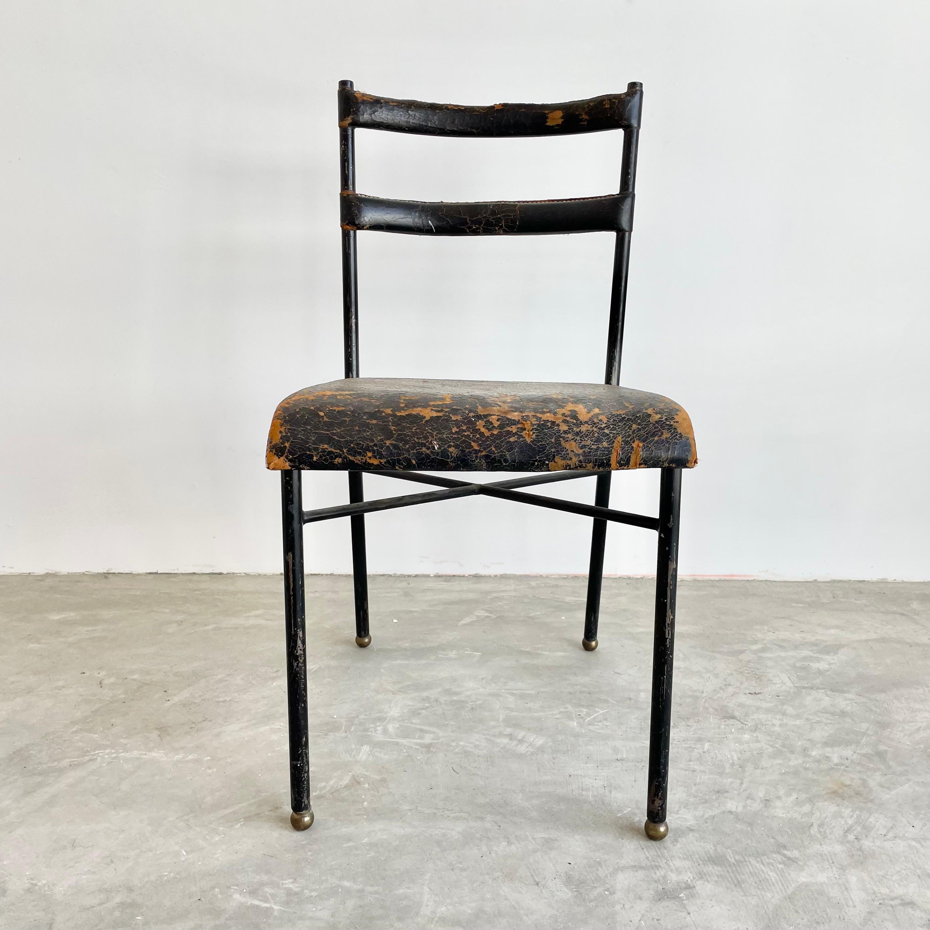 Original side chair by French designer Jacques Adnet. Iron frame with black leather seat and seat back. Signature Adnet contrast stitching throughout as well as brass ball feet. Completely original and unrestored. Wear as shown. Great piece of