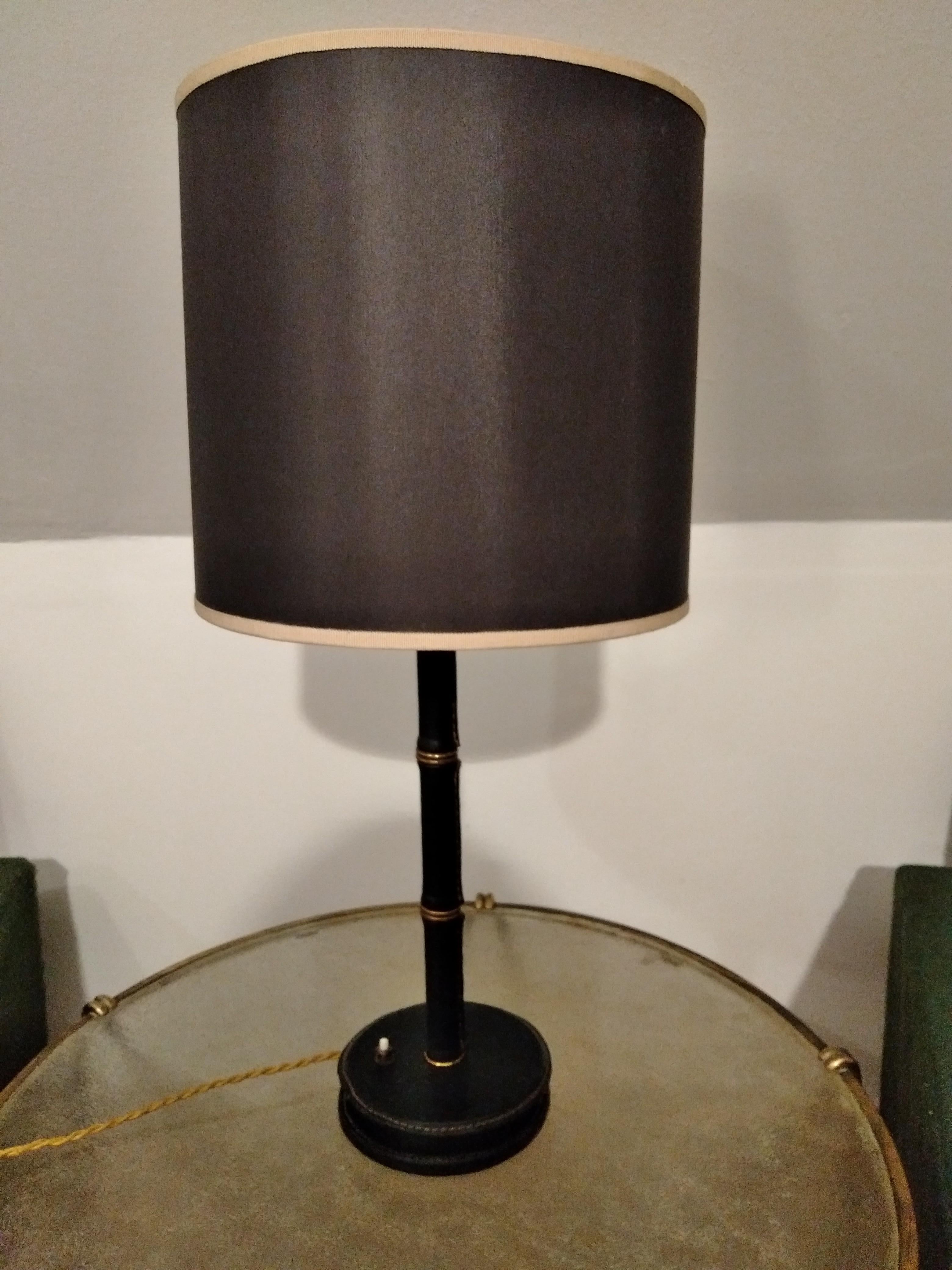 A stitched leather table lamp designed by Jacques Adnet in France in 1950s.
Bamboo form with handstitched leather and brass rings are characteristic of the Jacques Adnet's work.
French bayonet socket, bakelite switch and new wiring.
The
