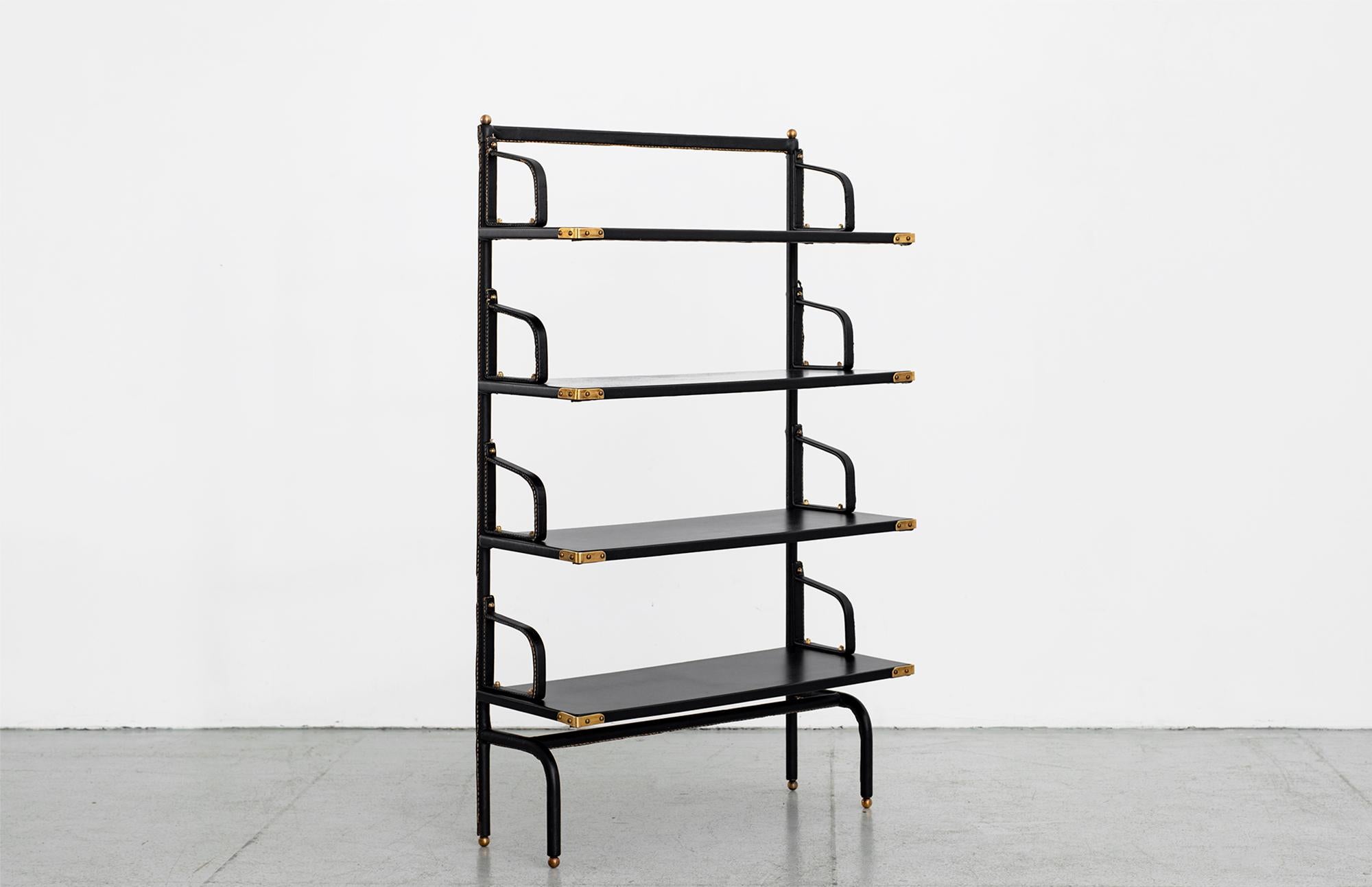 Stunning bookcase by Jacques Adnet, circa 1930s
Classic original black leather with contrast stitching and brass hardware.

Measures: W 26 1/2”
D 11”
H 43 1/2”.

 