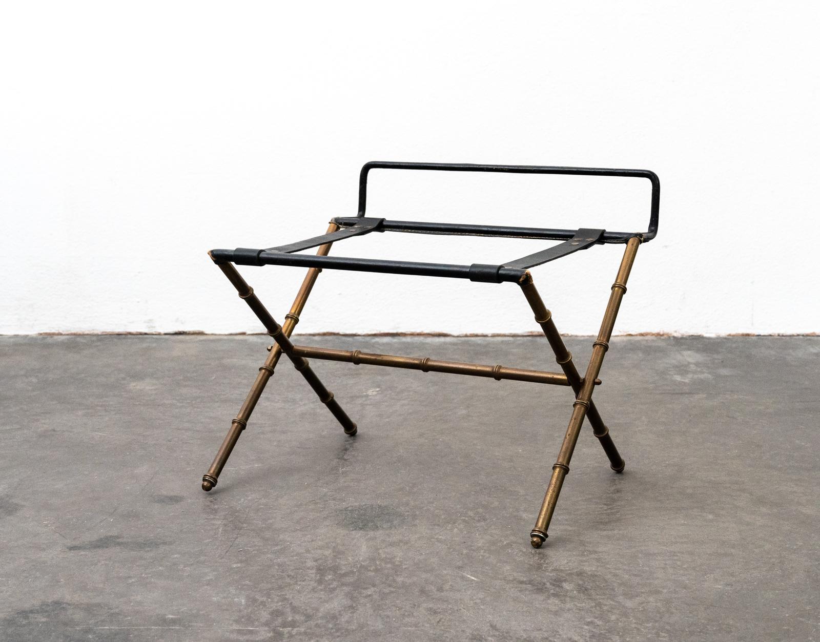 Foldable luggage rack in thick pique-sellier leather and brass faux bamboo by Jacques Adnet supplied to the Majestic hotel in Cannes around 1955
(Open dimensions: 61cm W x 51cm H x 55cm D)

Jacques Adnet was a French art deco modernist designer,