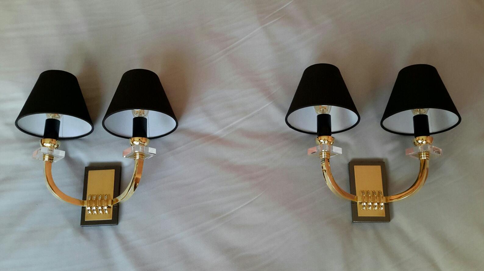 Very elegant pair of 2 arm gilded bronze, metal gun patina, brass and Lucite (plexiglass) double arm wall sconces in the French neoclassical style of the 1950s by Jacques Adnet.
The sconces are in a excellent condition, new rewired and suitable for