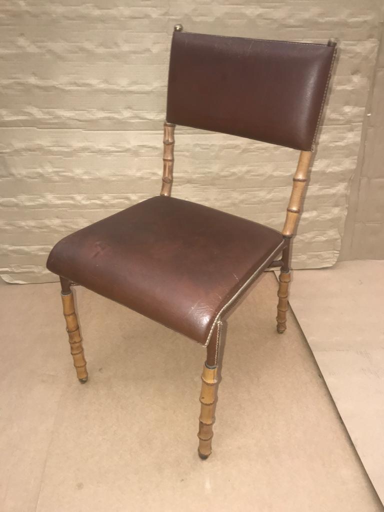 A rare leather and bambou style legs chair designed by Jacques Adnet in France in 1950s.
Original leather with some wear.
It comes from an important collection in the south of France.
Shelves, floor lamp, magazine rack and pair of armchairs with