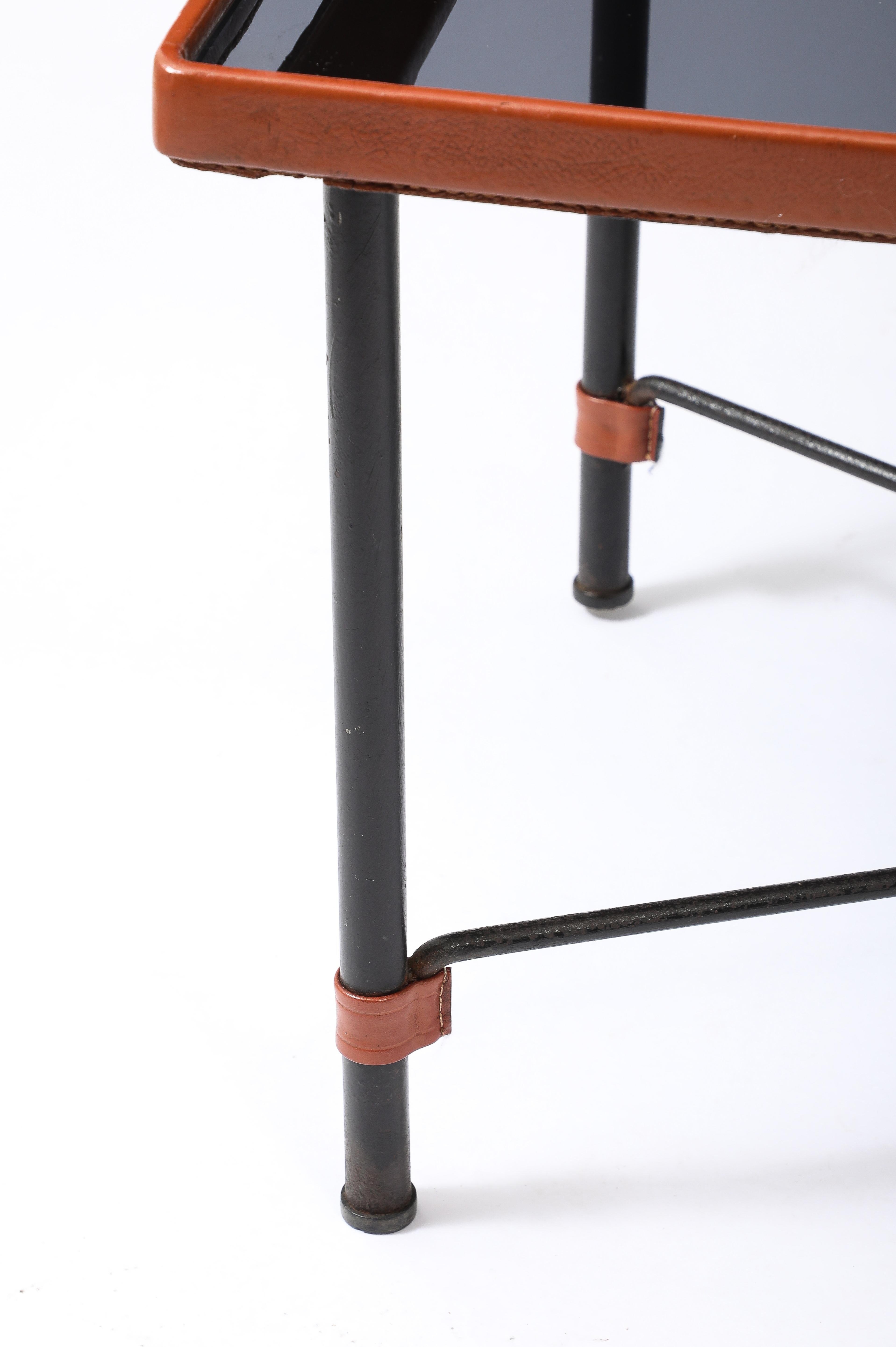 Blackened wrought iron and original stitched leather coffee table with a smoked glass insert.
