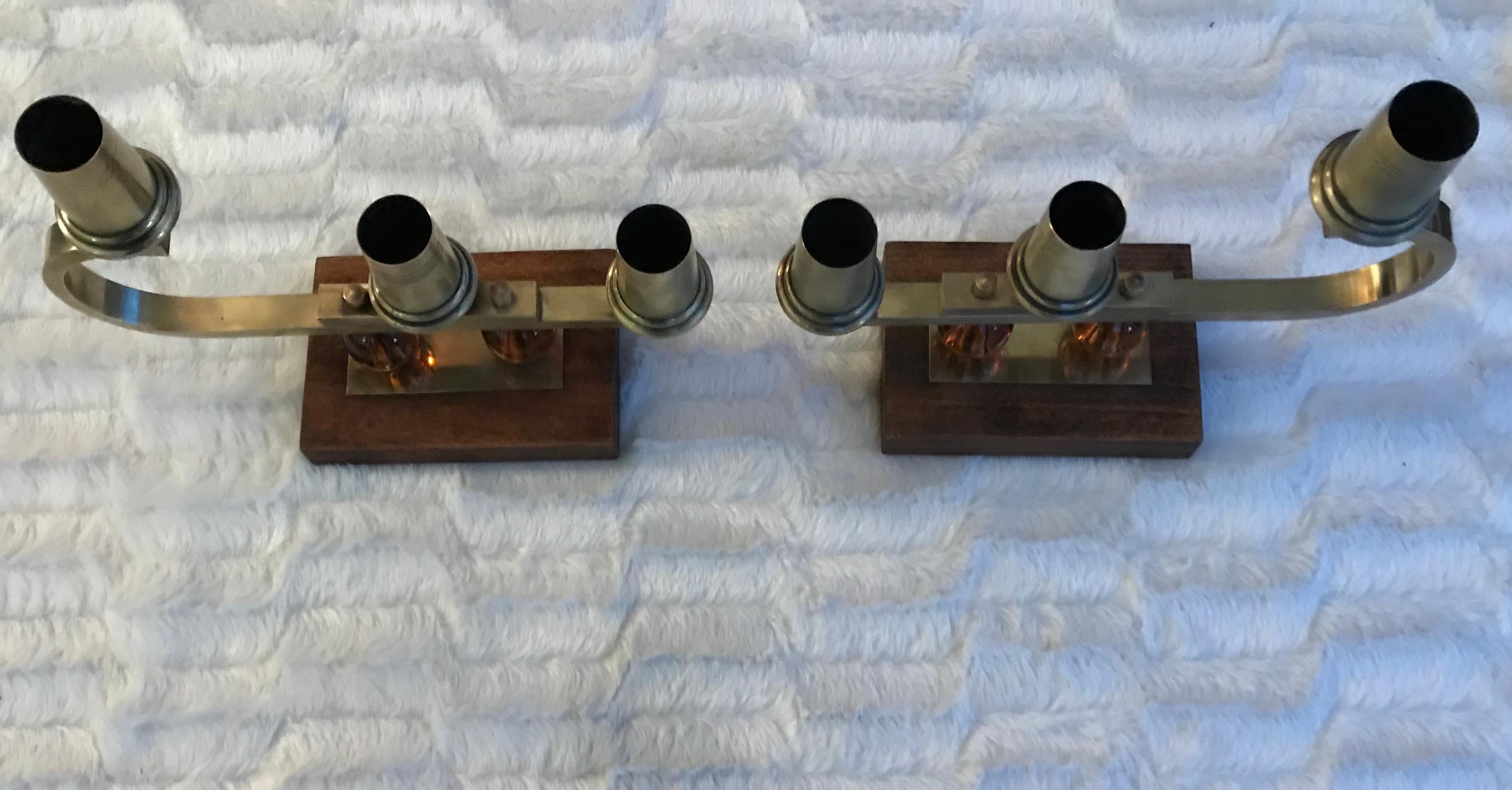 Gorgeous pair of Candlesticks in the style of French Designer Jacques Adnet.
Each candlestick holds 3 candles, total 6 candles for this set.
Very elegant combinantion and modern shapes presenting a wood base, glass and brass .
