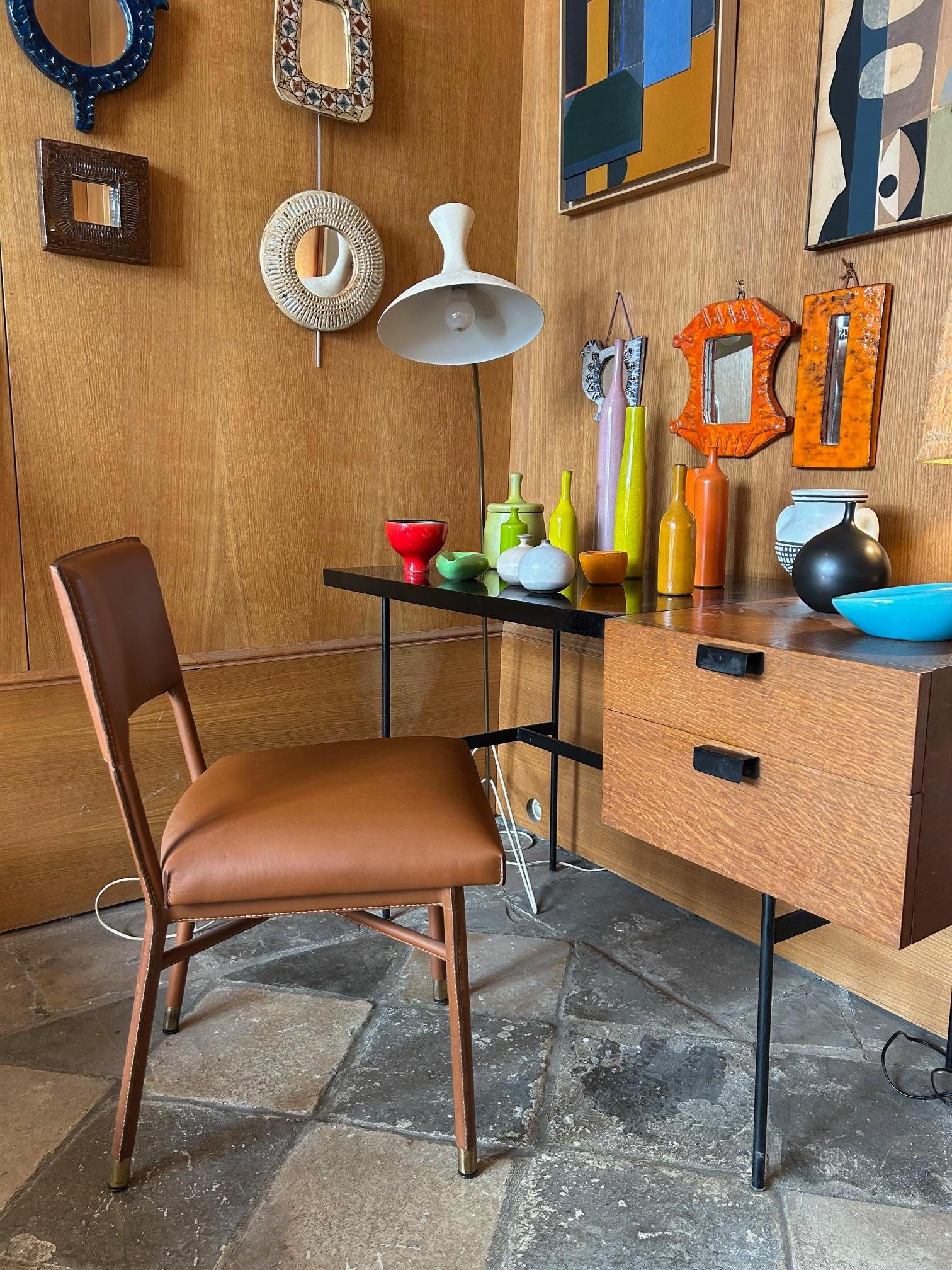 Elegant set of four Jacques Adnet chairs covered with leather hand stitched piqué-sellier.