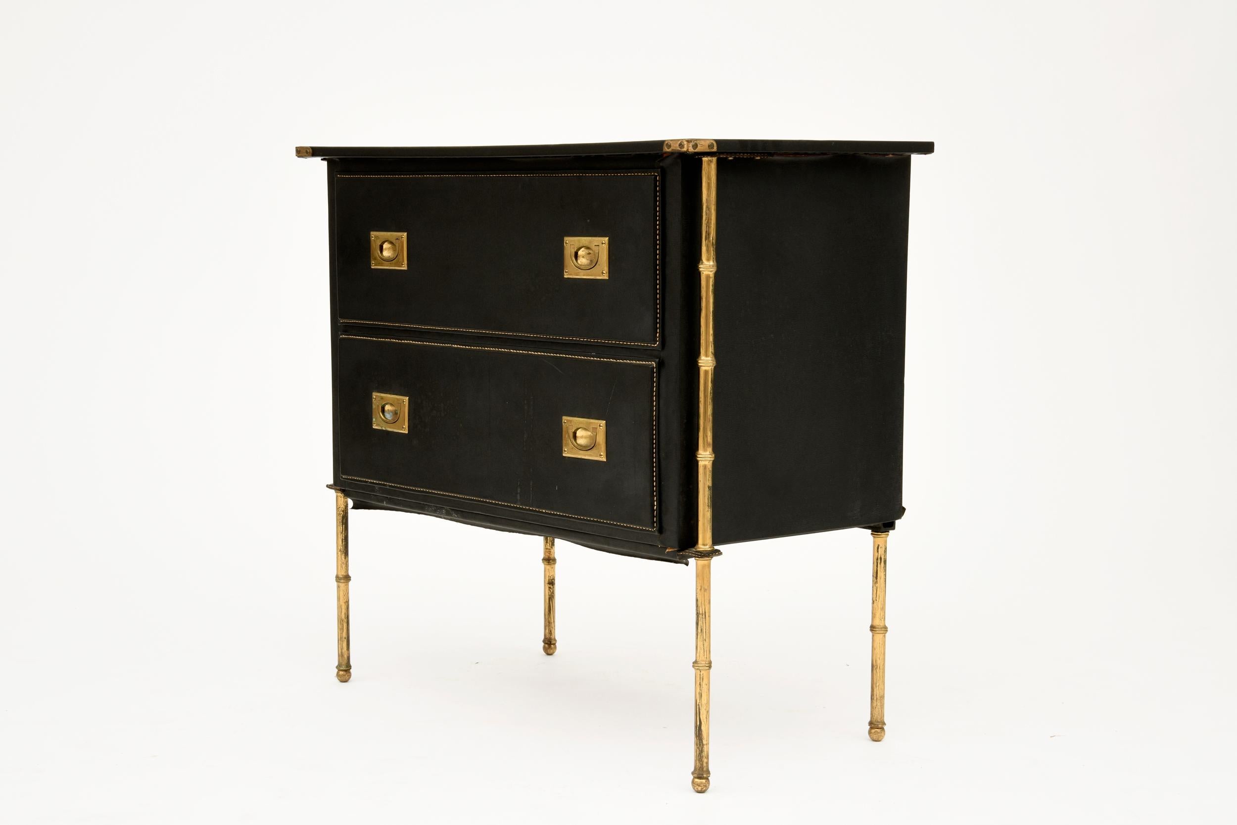 Beautiful chest of drawer by Jacques Adnet in metal and leather from circa 1950. Presenting signature element of Adnet's design as leather covering (with stitchings) and bambou like metal legs. Great original condition.