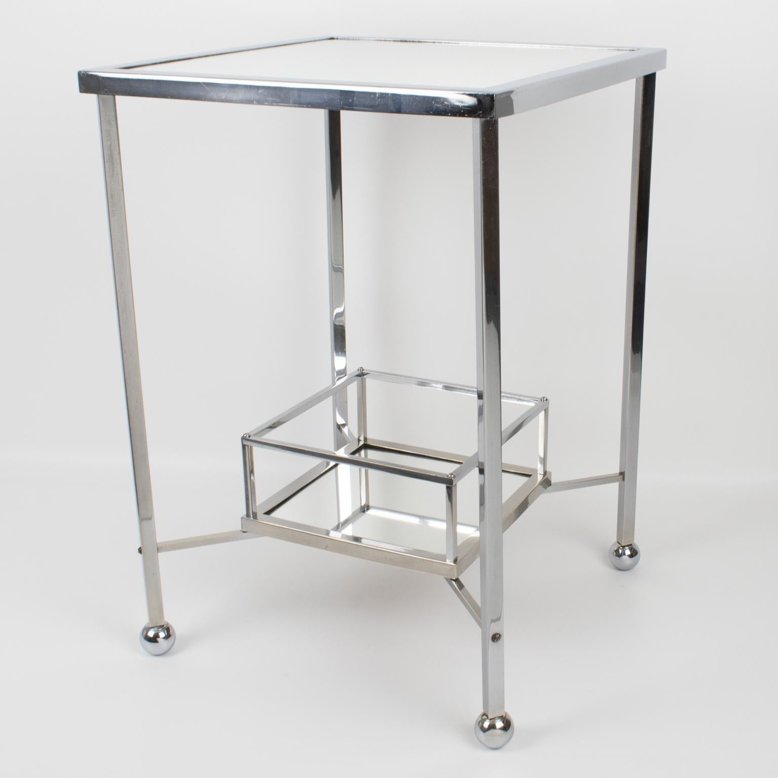 Jacques Adnet (1901 - 1984) designed this stunning Art Deco occasional bar cart or side table circa 1930. The minimalist chic construction boasts a square shape with a mirrored glass tabletop and a bottle tray on the bottom. The table is made of