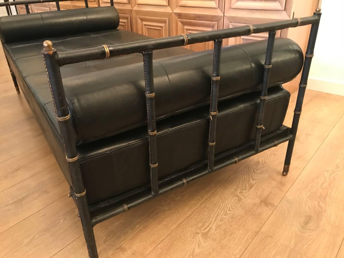 French midcentury hand-stitched black leather daybed by Jacques Adnet. Leather mattress and bolsters, interior steel frame, brass accents. Excellent vintage condition.
 