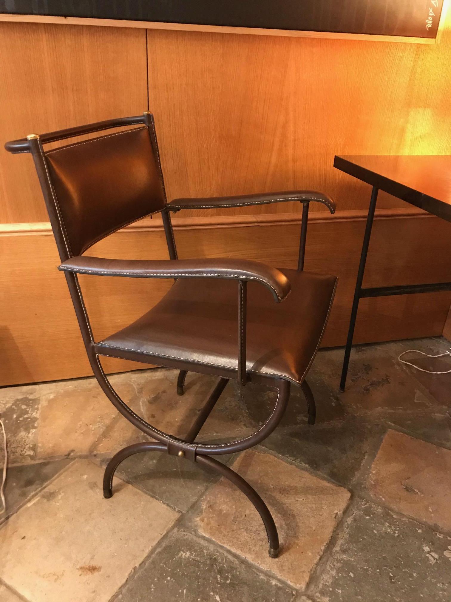 Jacques Adnet desk armchair, France, 1950s. Piqué-sellier brown leather.