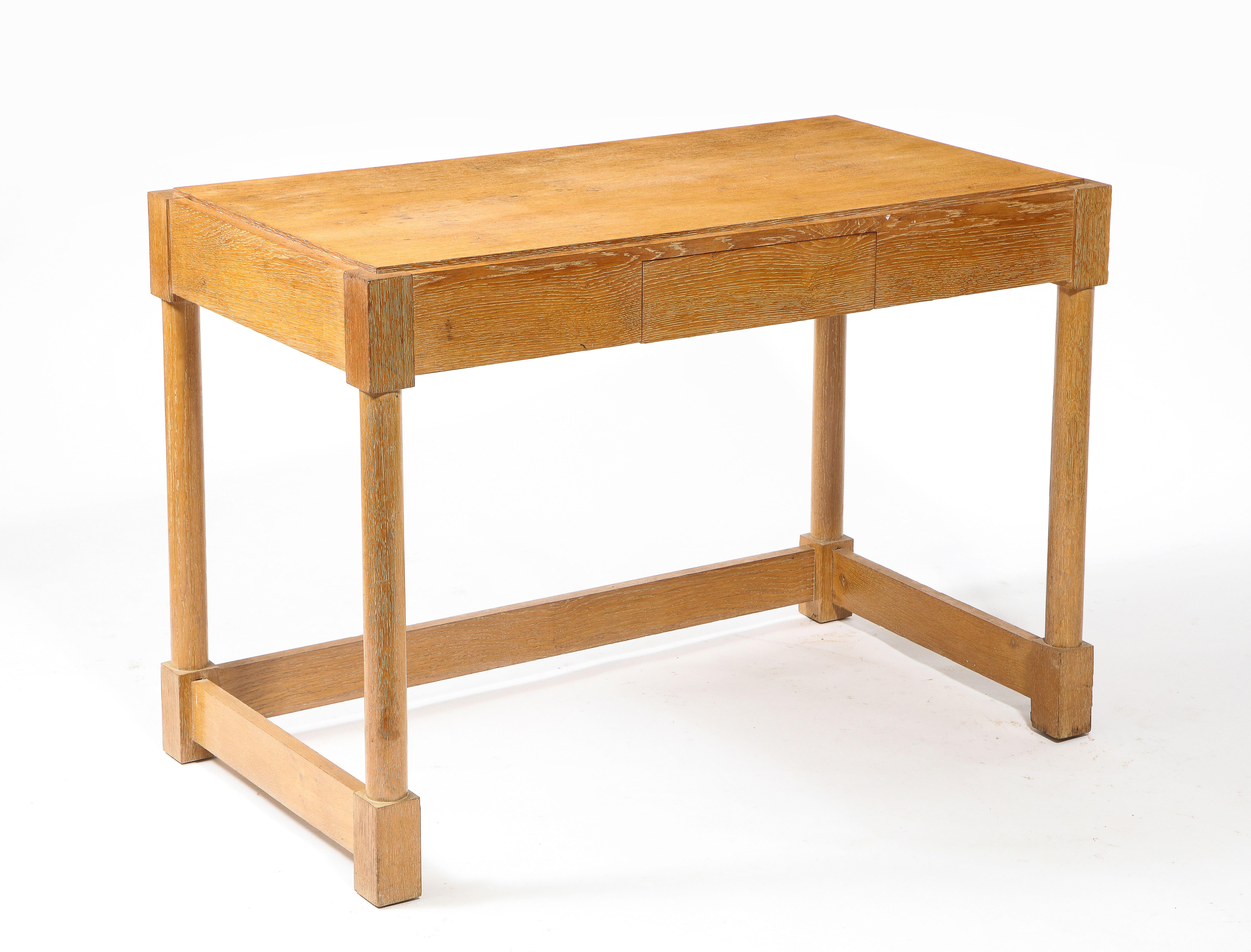 Handsome oak desk with a single drawer by Jacques Adnet.