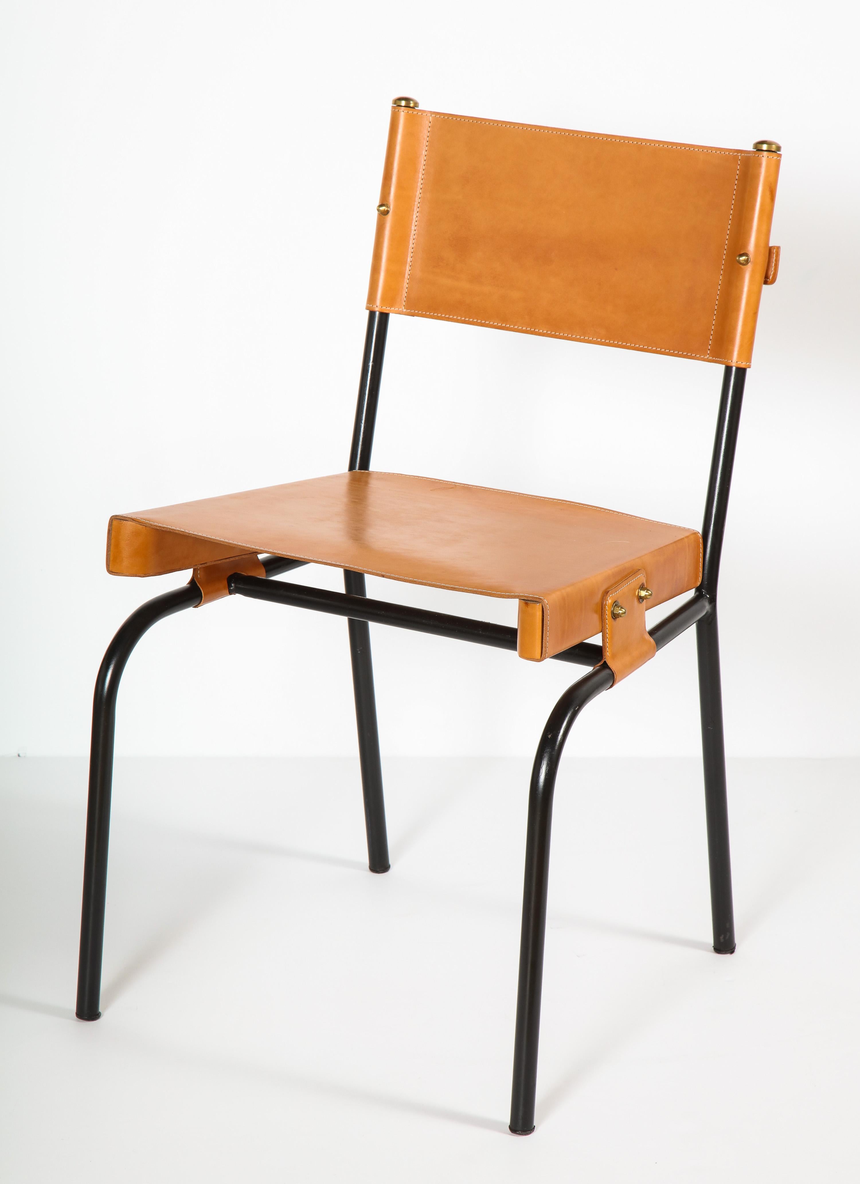 Exceptional set of Jacques Adnet dining chair with period correct leather restoration. Sold as a set or pair only.