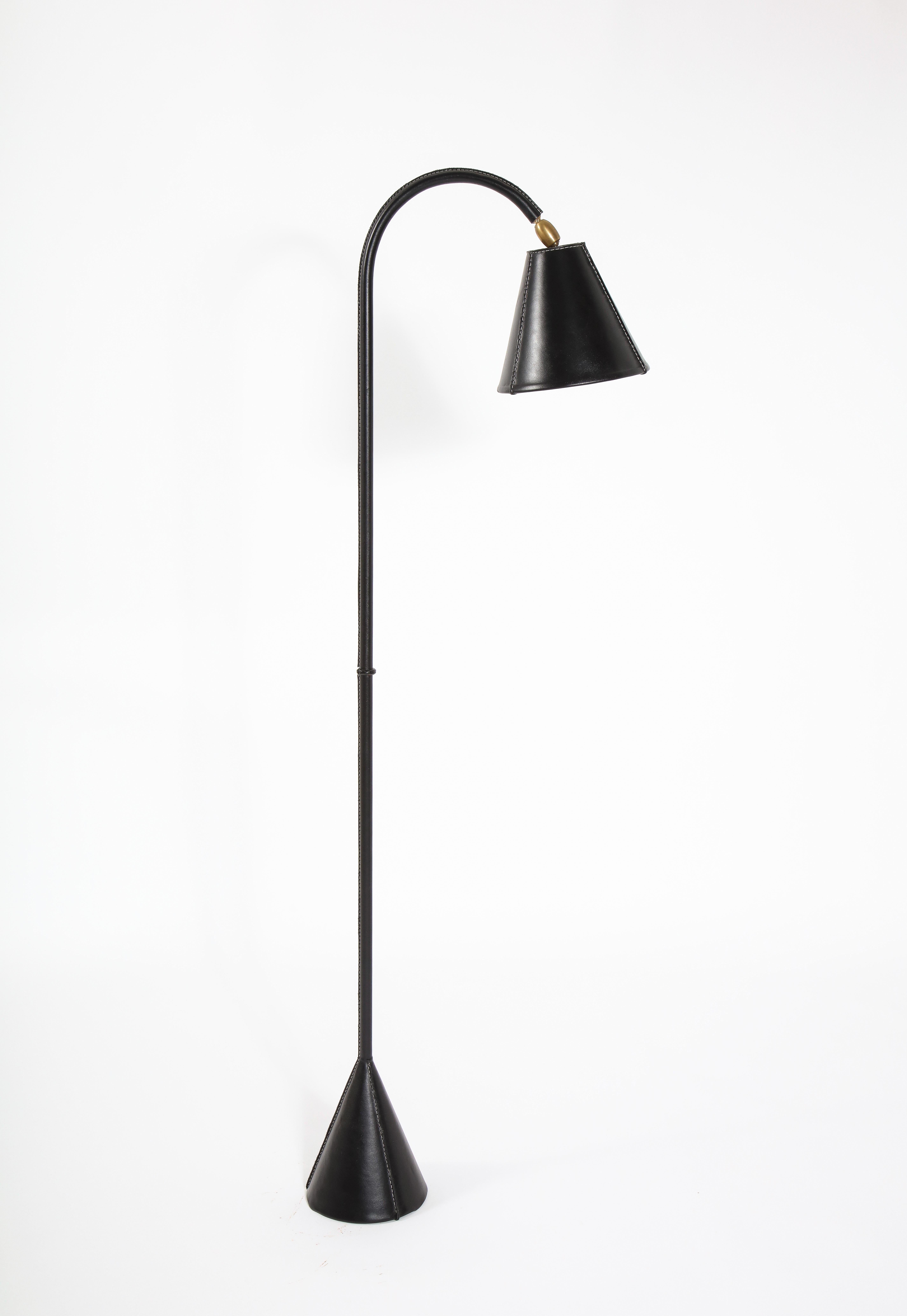 Elegant Jacques Adnet reading floor lamp wrapped in hand-stitched black leather. Leather was replaced by the foremost Adnet restorer in the united states, documentation upon request.