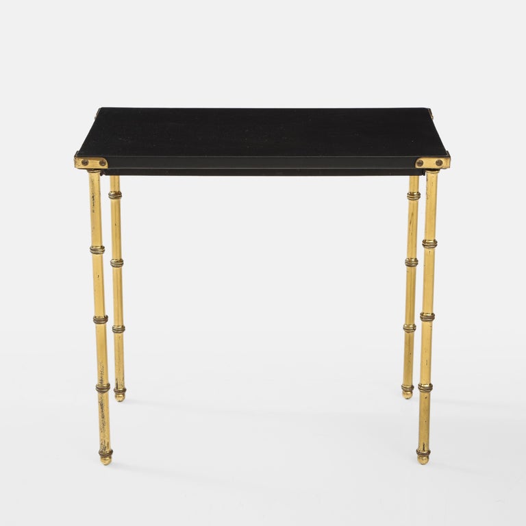 Jaques Adnet faux bamboo side table with top wrapped in original black skaï and faux bamboo brass legs. This table has remained in completely original and very good condition and are free of tears or other significant damage to the original skaï.