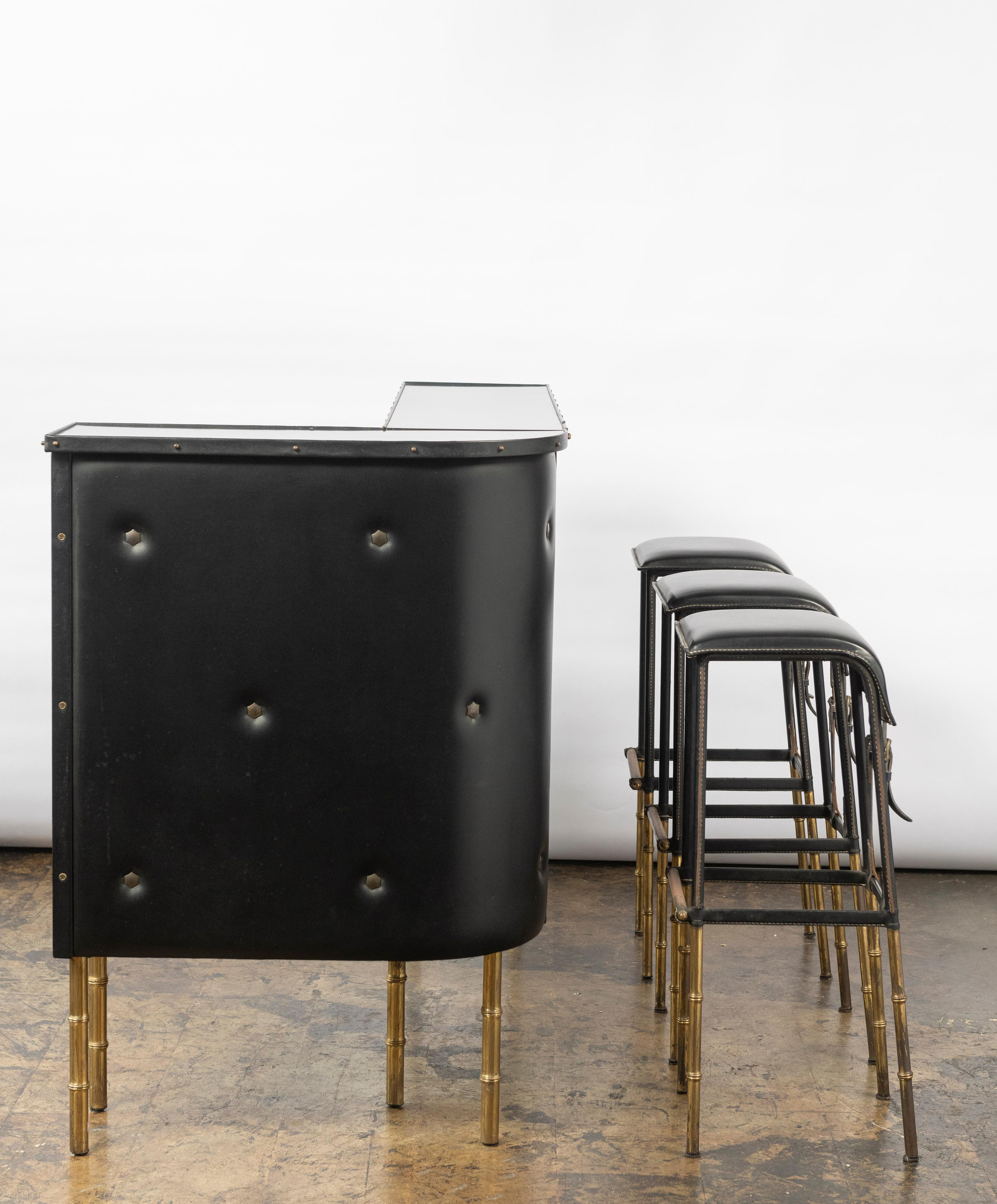 It's rare to find this sophisticated faux leather bar, we believe in the style of if not Jacques Adnet itself. We've sold the stools and the bar is still available. The piece is representative of both the sleek lines of Adnet and the industrial