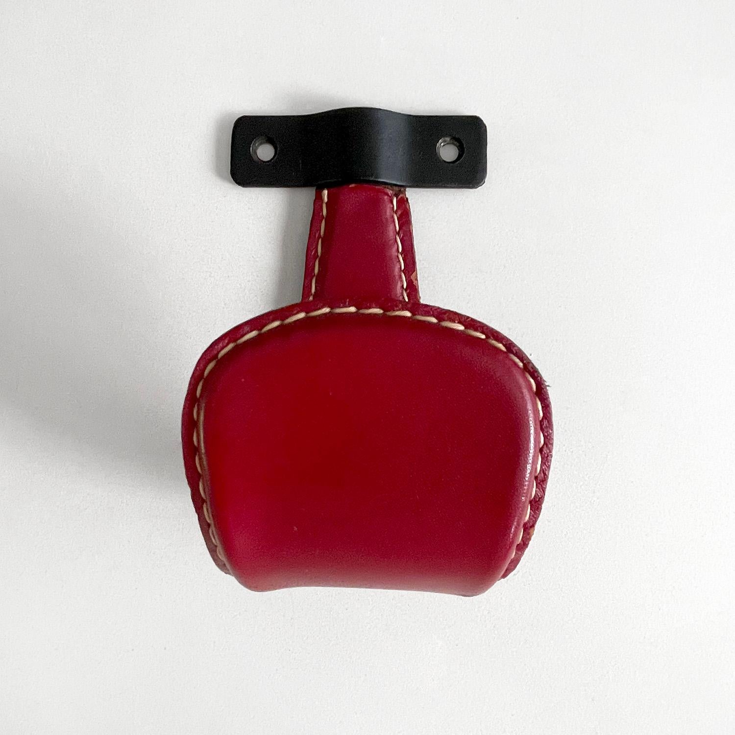 Jacques Adnet red leather & iron hook
France, circa 1940's
Wall mounted iron hook
Frame is wrapped in fire engine red leather
Signature contrast stitching
Light surface markings
Patina from age and use
Two hooks available
Sold separately
Last two