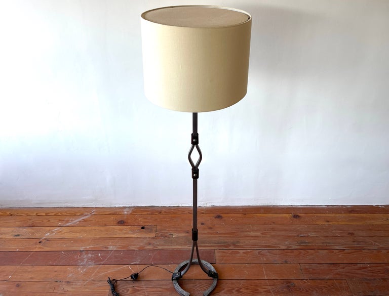 Handsome Jacques Adnet attributed floor lamp with heavy iron and leather detail. 
Horseshoe shaped base. 
Newly rewired and new silk shade. 
France circa 1950s