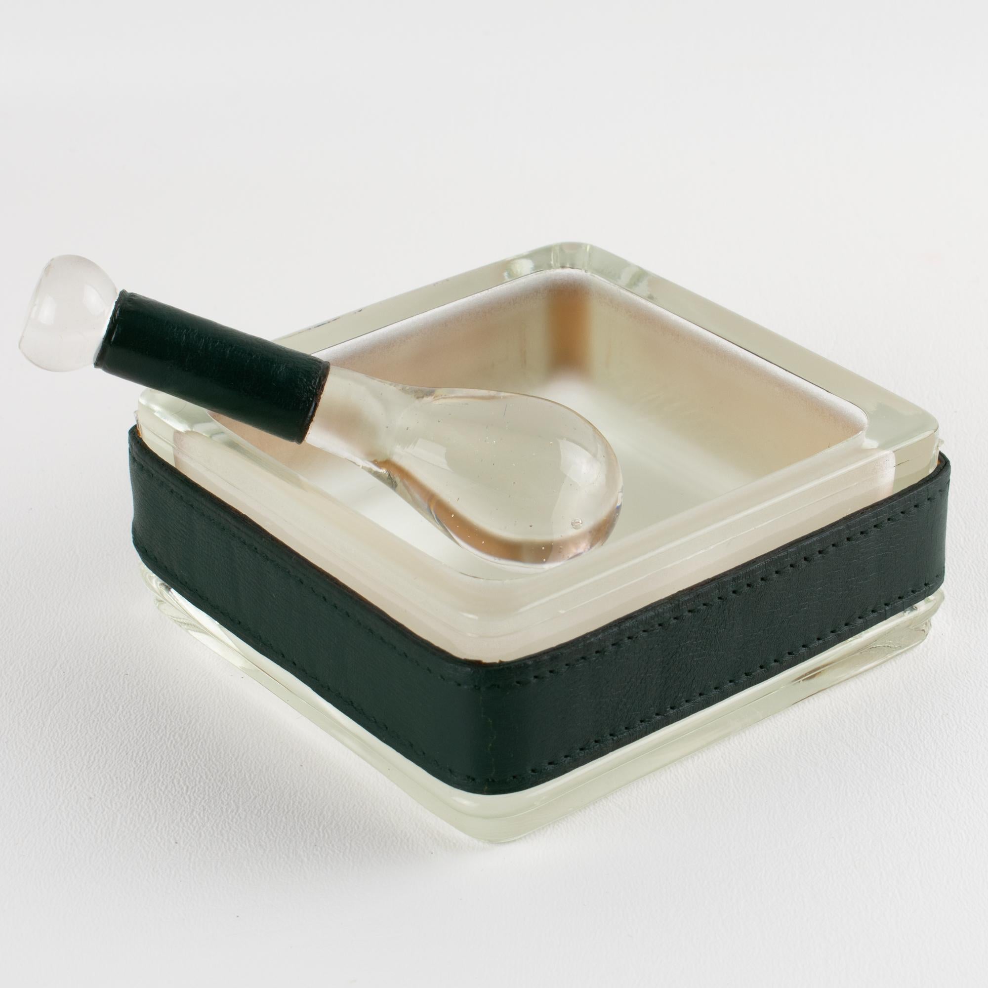 Designed by the acclaimed French modernist Jacques Adnet (1901–1984), this striking desk accessory exemplifies his iconic blend of luxury and functionality. The set was expertly crafted in France circa 1950. Fashioned from molded glass with inside