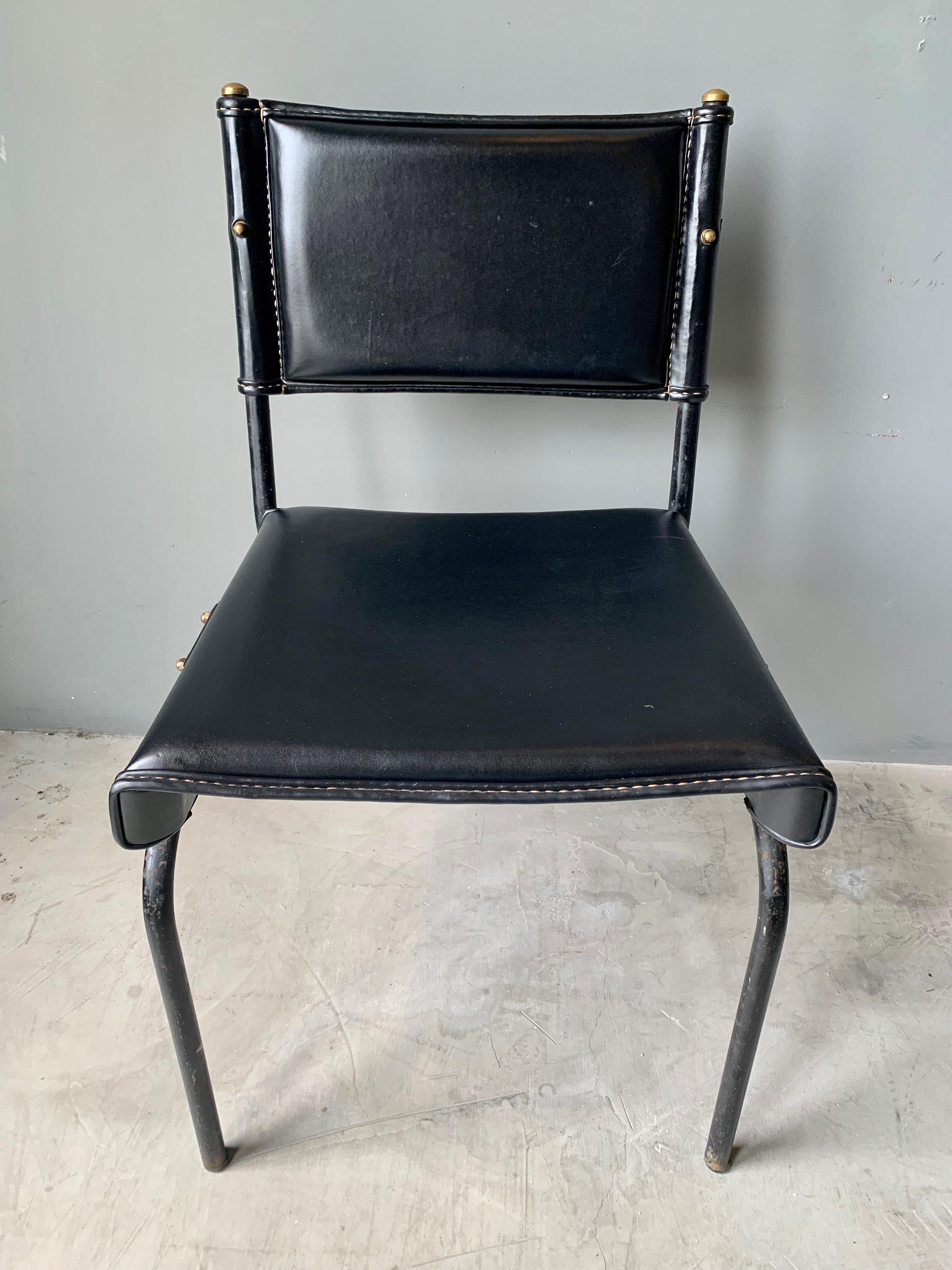 Stunning chair and footstool by French designer Jacques Adnet. Iron frame with black leather throughout. Original leather in very good condition. Signature Adnet contrast stitching. Gorgeous set.


Chair dimensions: 31.5