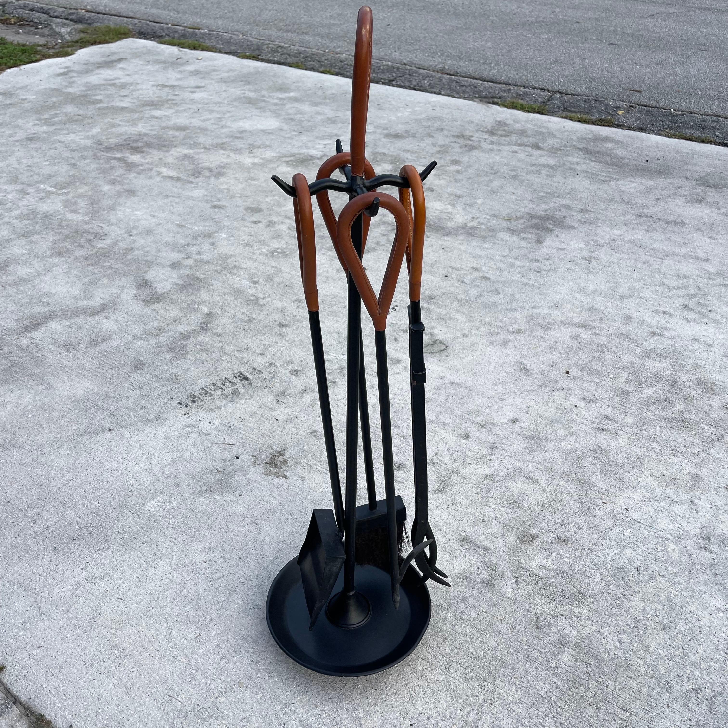 Fabulous set of leather & iron fireplace tool set, in the style of Jacques Adnet.