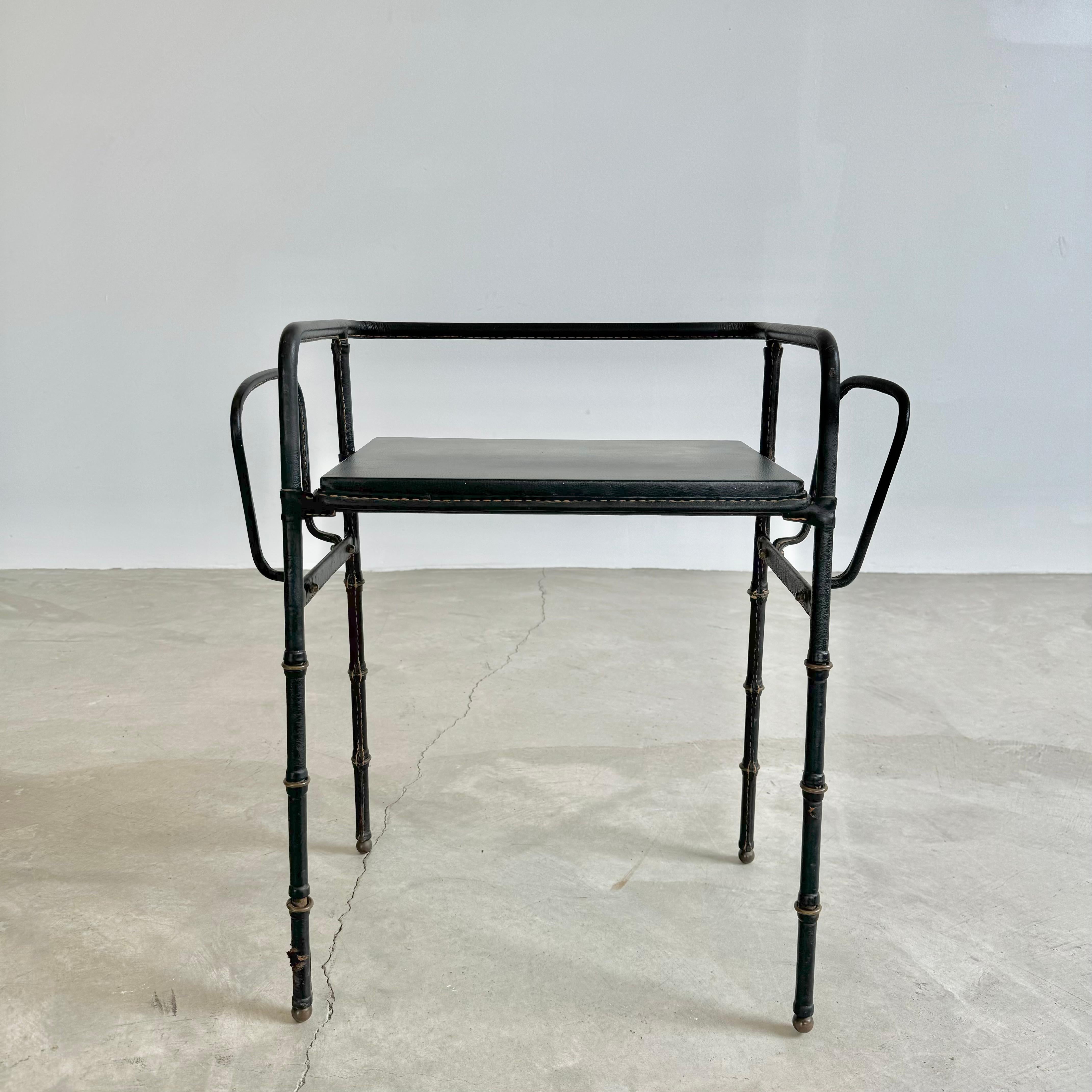Stunning leather side table with dual magazine racks by French designer Jacques Adnet. Table top stands at 18.5