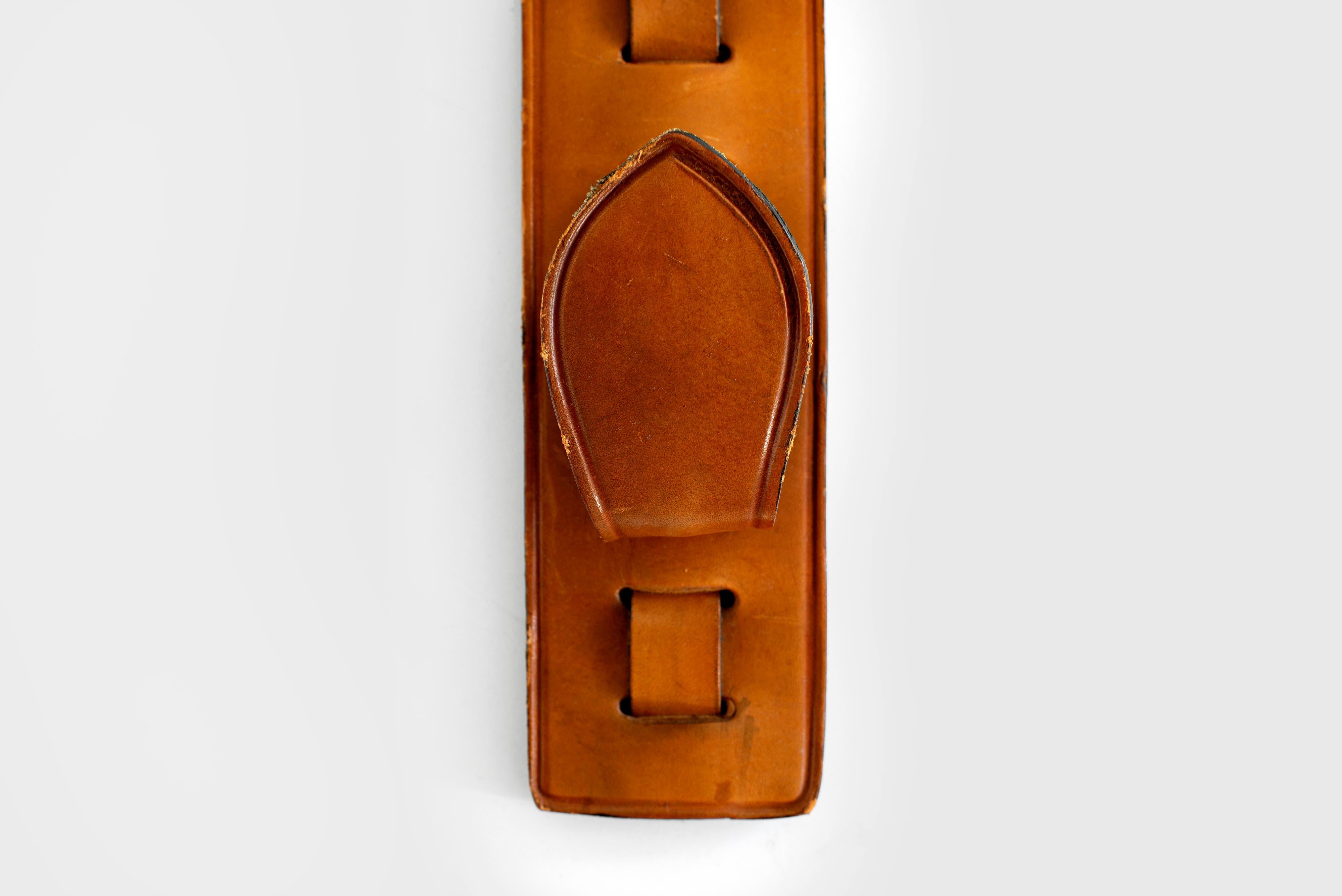 Beautiful equestrian and hunting set of three hooks on leather panel. 
Saddle leather with brass.
     