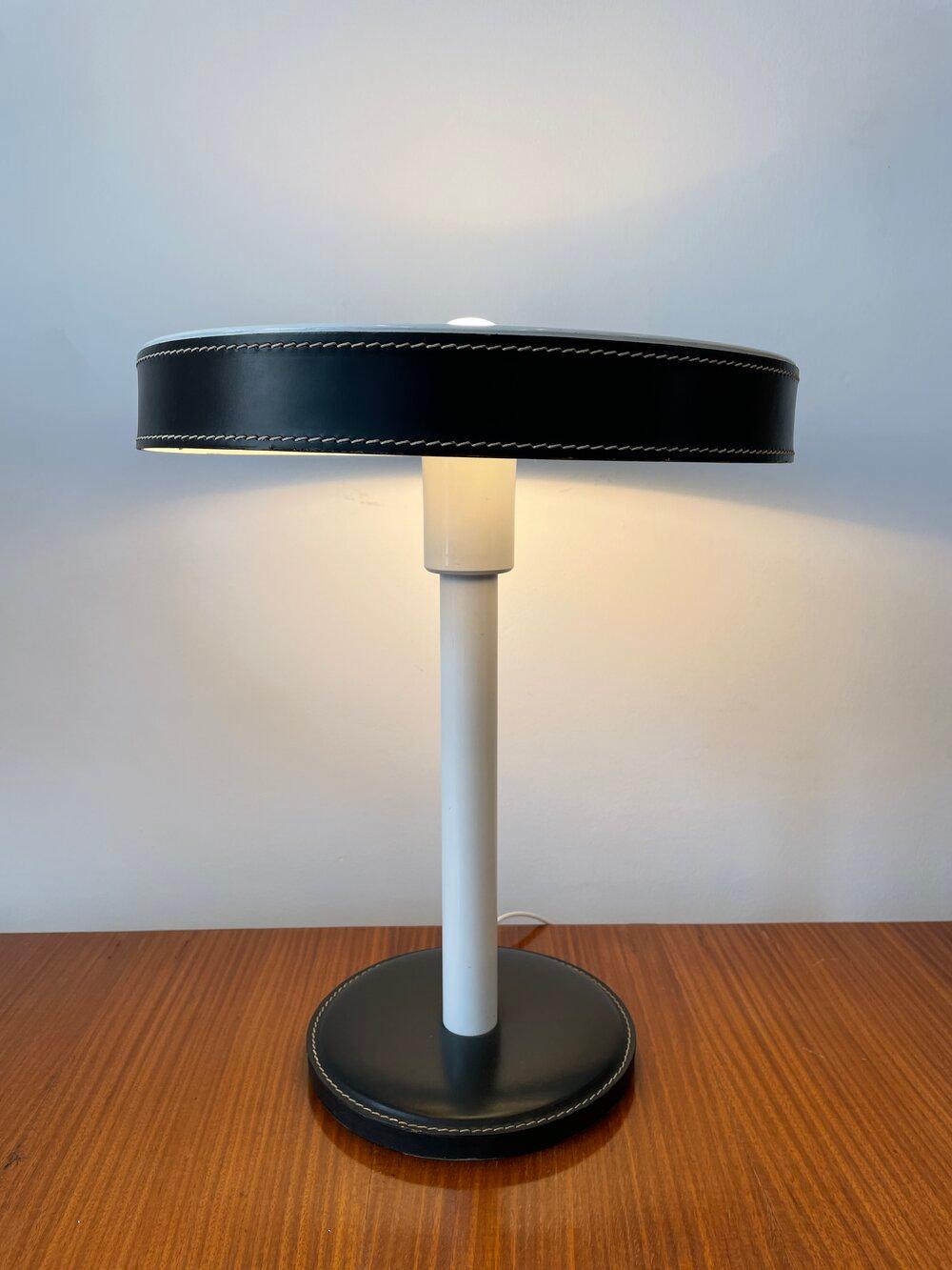 Jacques Adnet leather with metal base table lamp with stitch detailing.
 
 
   