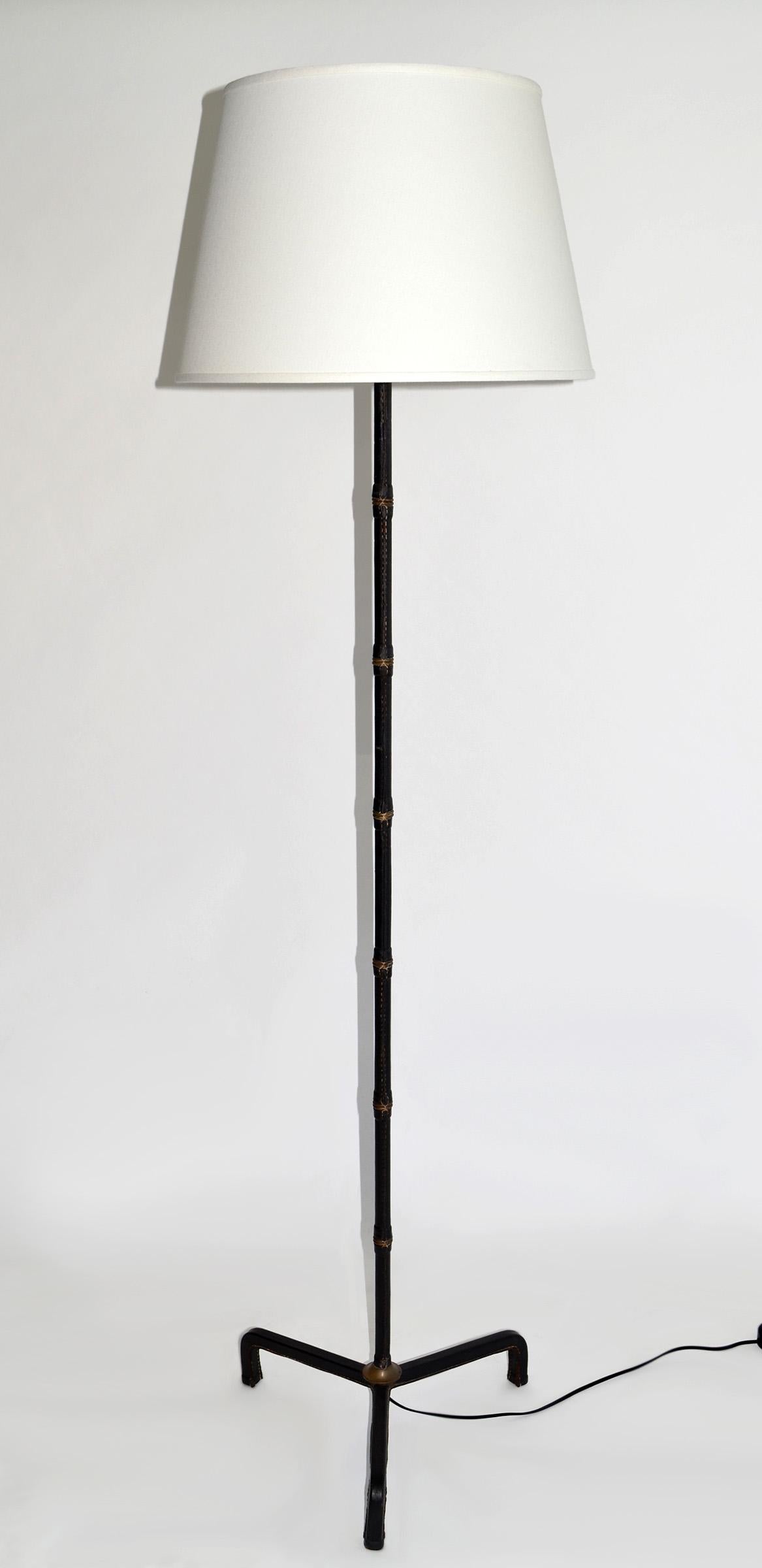 Jacques Adnet Leather wrapped Floor Lamp, France c. 1950
France, c. 1950
saddle-stitched leather, brass
65 x 19 diameter to top of shade. 58 x 18 no shade. 

Good overall condition. Newly wired for American outlets with a single socket for a