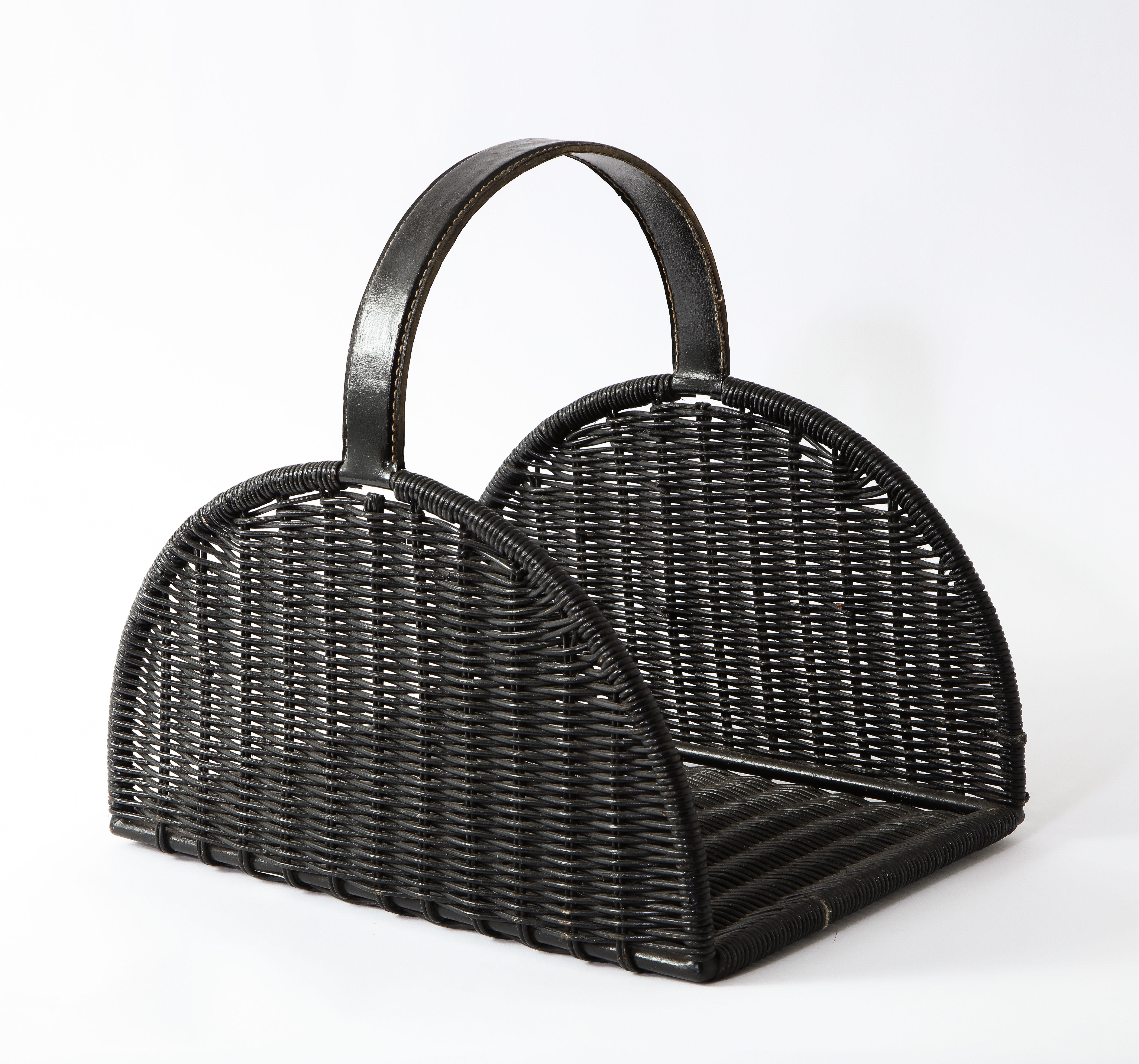 A leather and wicker basket after Jacques Adnet. It can be used as a log holder or magazine basket, very versatile and good scale.