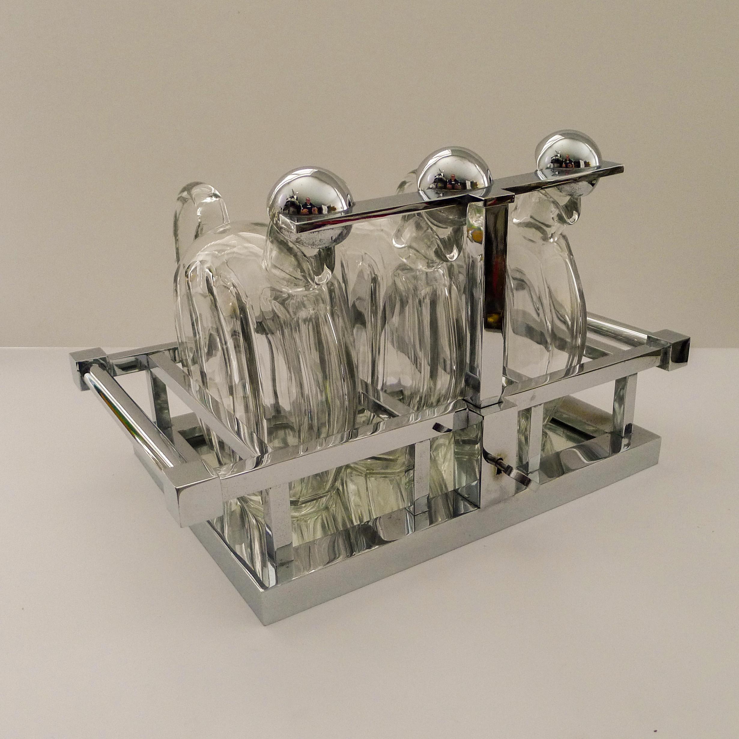 A rare find and in superb condition. This wonderful modernist tantalus is made from chromed metal with a mirrored base on which the three fabulous faceted decanters stand, each signed on the underside.

Please see: ” Jacques Adnet ” by A R Hardy