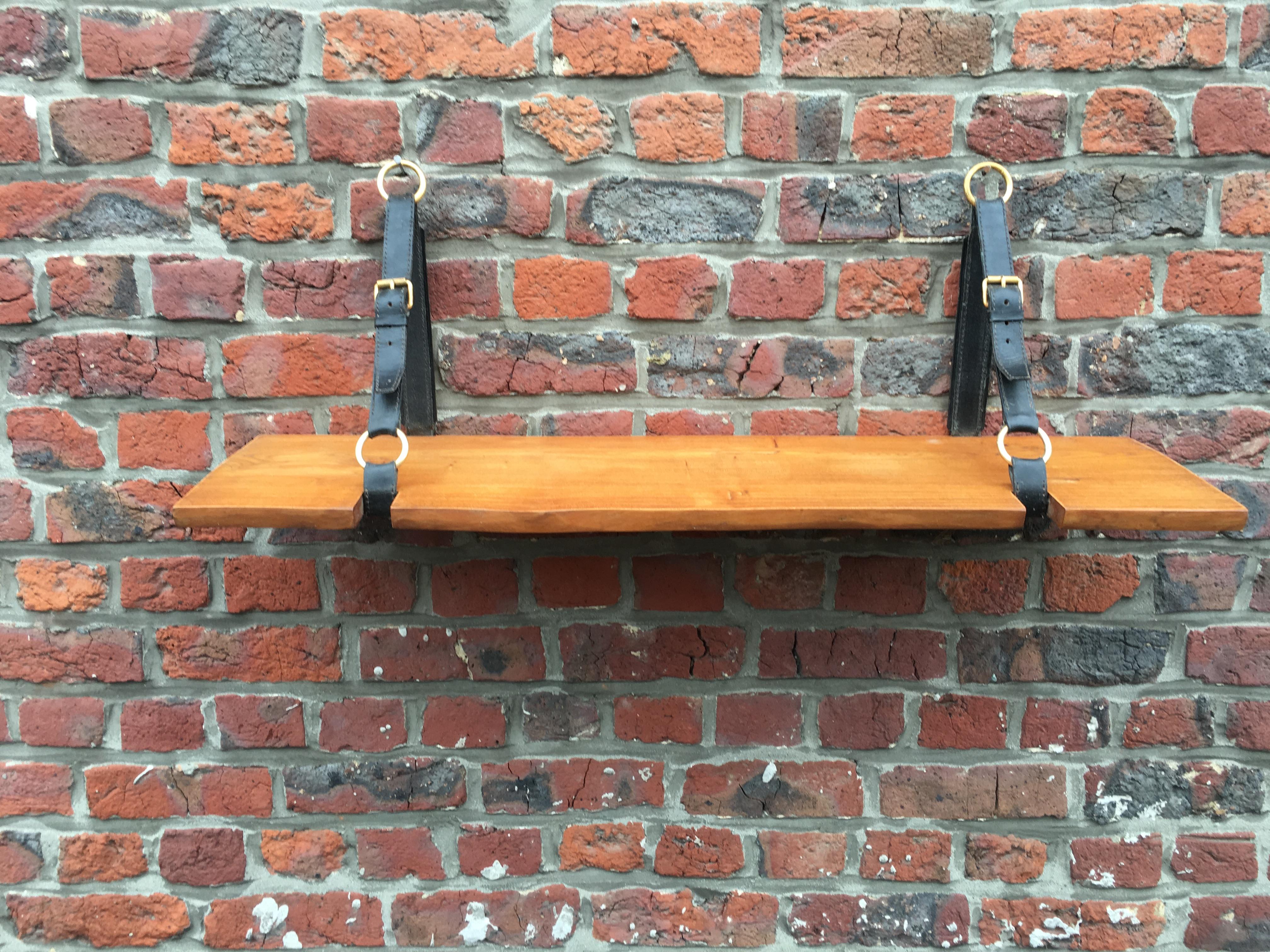 Jacques Adnet oak and leather wall shelf, circa 1950.