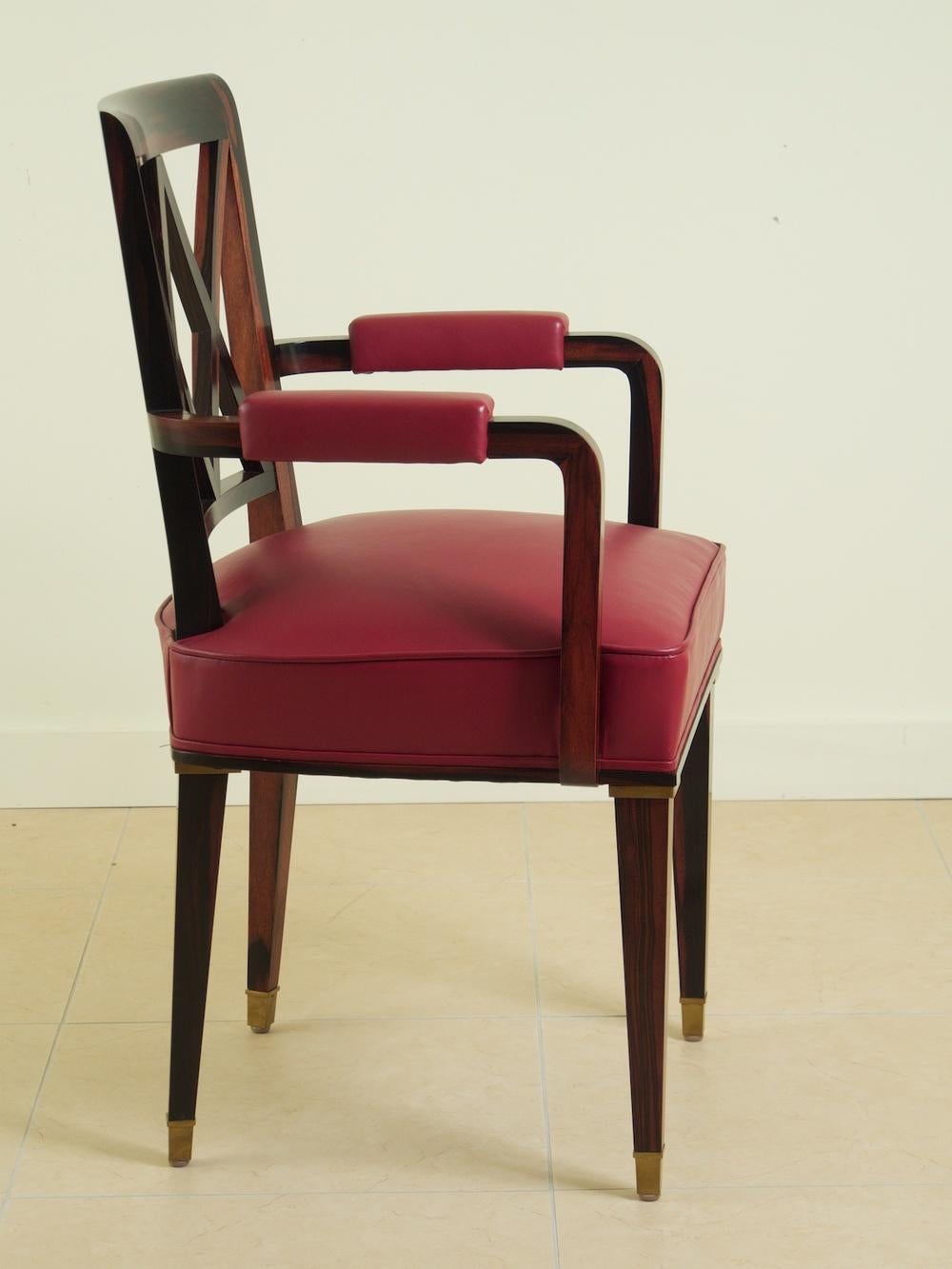 French Art Deco pair of pull-up armchairs by Jacques Adnet, circa 1936. Solid macassar ebony with bronze mounts. Red leather upholstery. 22