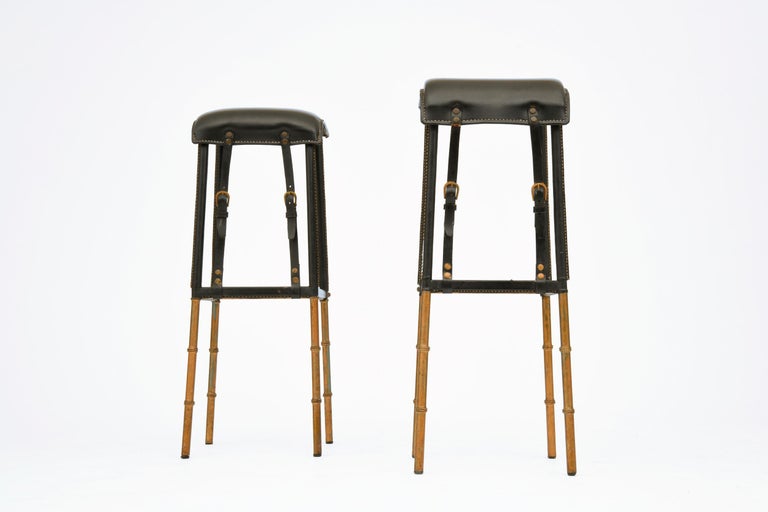 Pair of leather and metal bar stool by Jacques Adnet, c. 1950. Great original condition, beautiful patina.