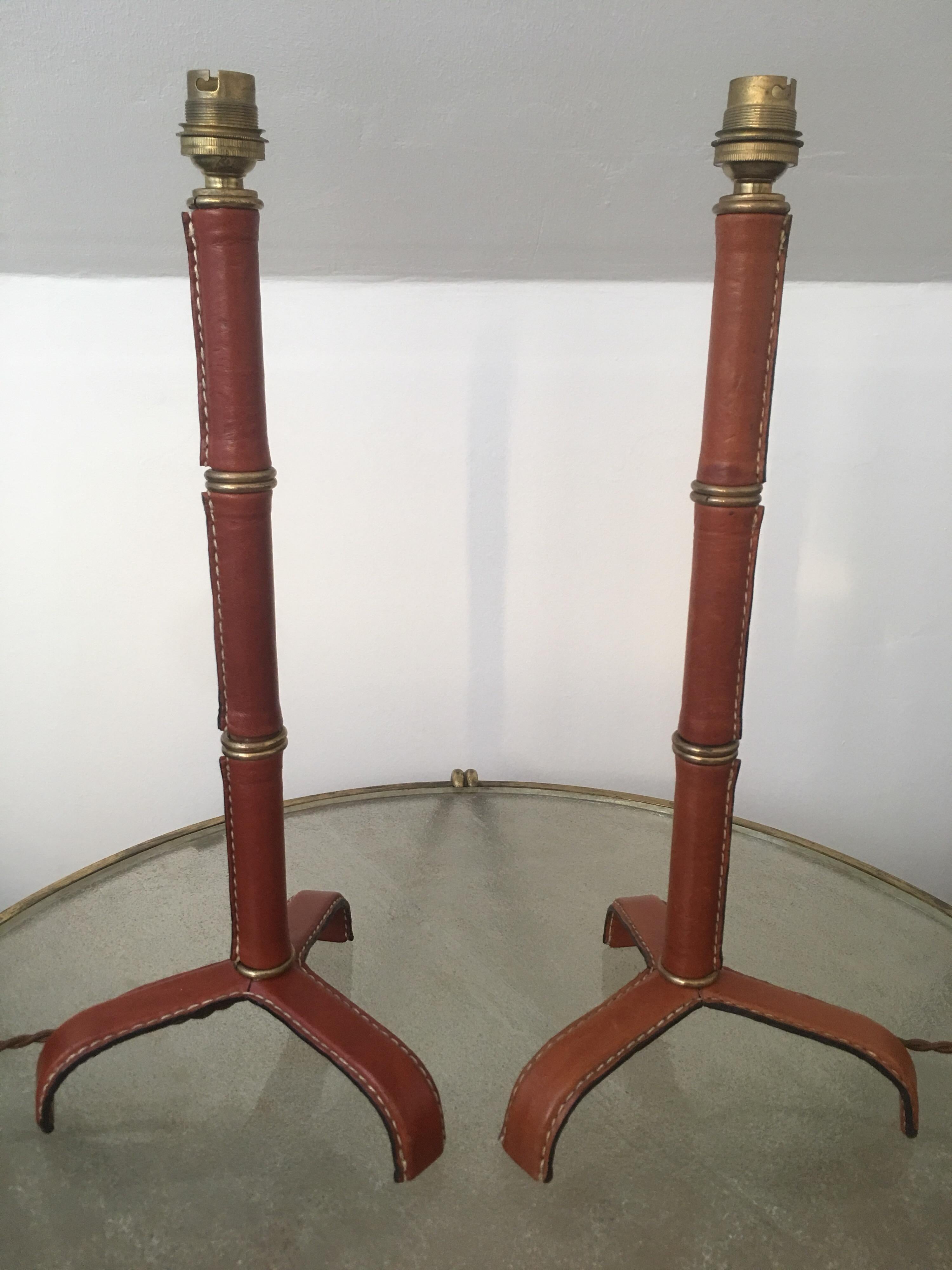 A pair of handstitched leather table lamps designed by Jacques Adnet in France in 1950s.
Bamboo form with handstitched leather and brass rings are characteristic of the Jacques Adnet's work.
French bayonet socket, bakelite switch and new