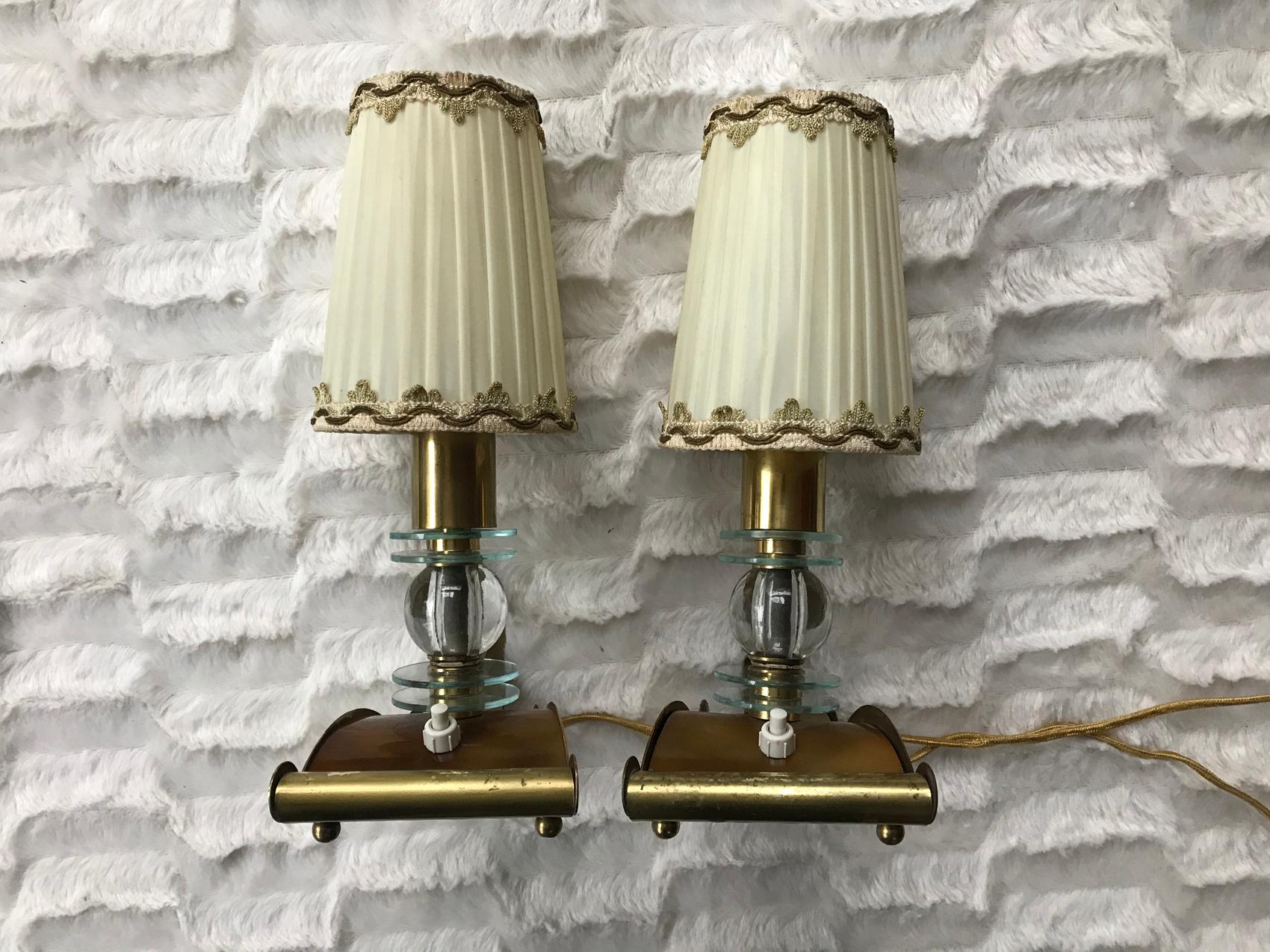 Rare pair of Jacques Adnet table lamps.
France, 1950s.
With its original lampshades.
In a very good general condition.
Dimensions of each one:
10 x H x 27 x 13 cm
With the lampshade D 10 x H 13 cm
Without the lampshade H 18cm.
 