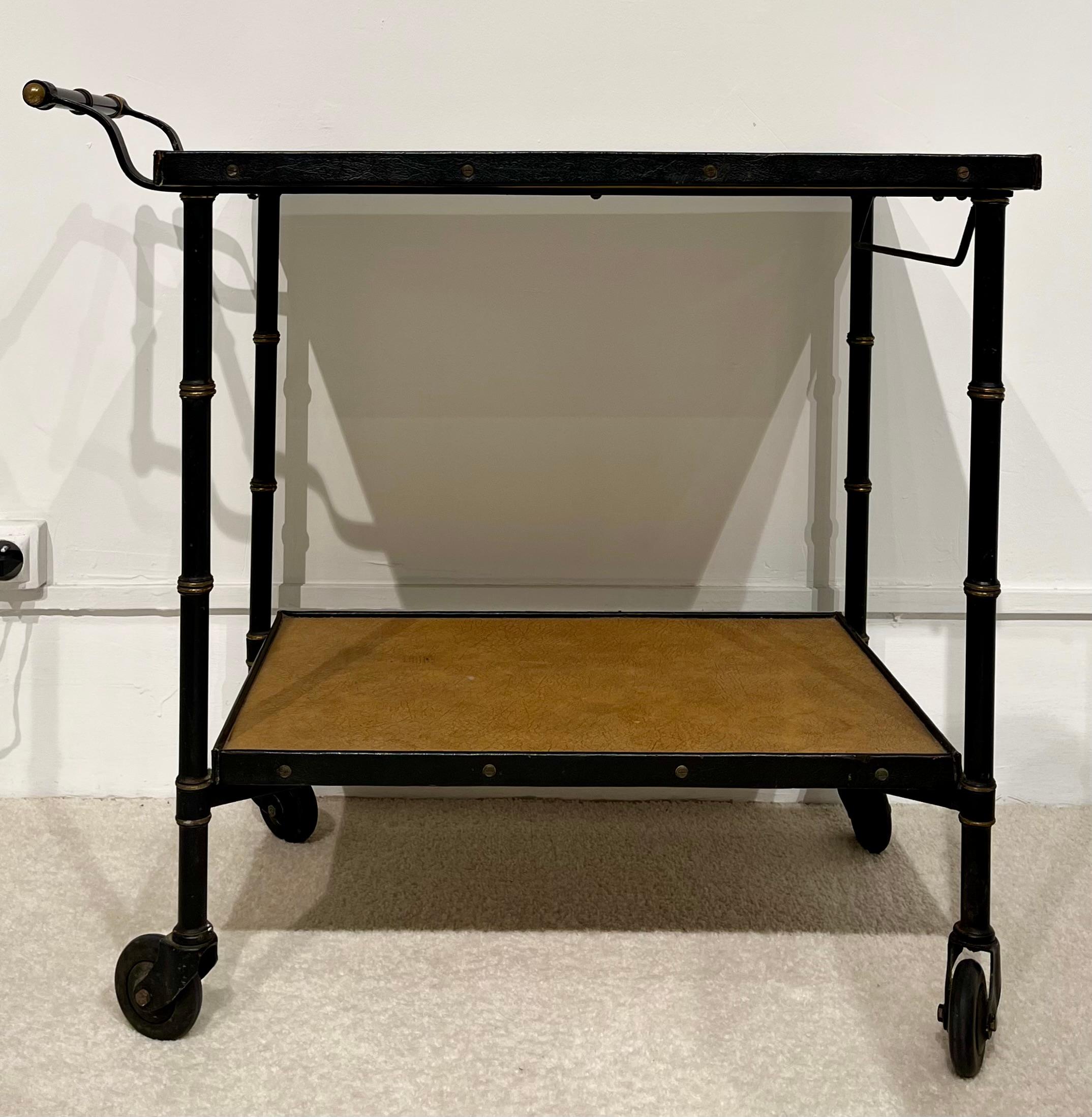 Jacques Adnet (1900/1984, France) : Four wheels rolling cart 

Two trays cart made of four bamboo foot in black lacquered metal ending with rolling wheels and drived by a handle
Both trays slices are covered by topstitched black thick leather strips