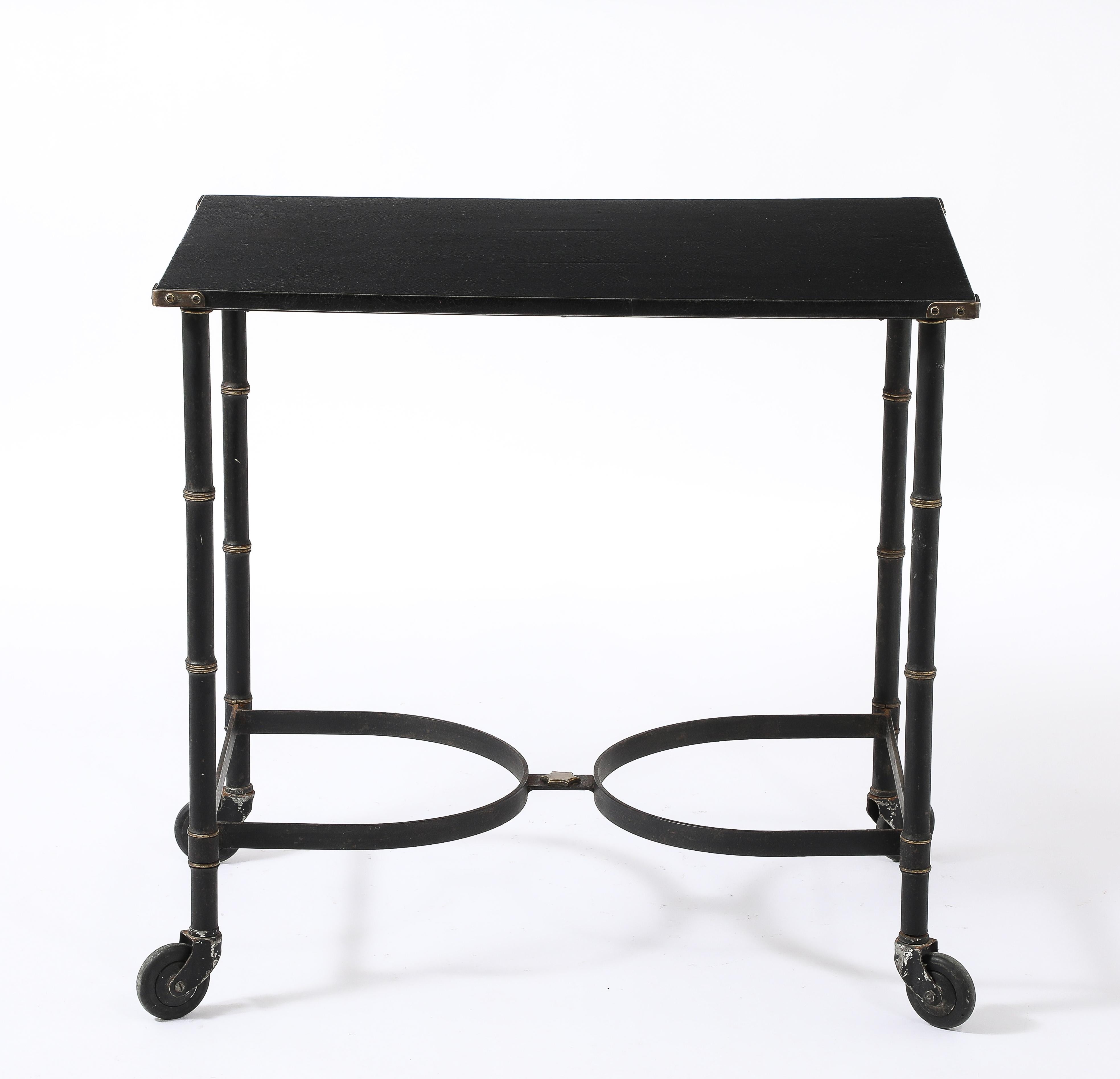 Blackened Wrought iron with faux bamboo brass details and a star finial, original Moleskin top with brass corners.
