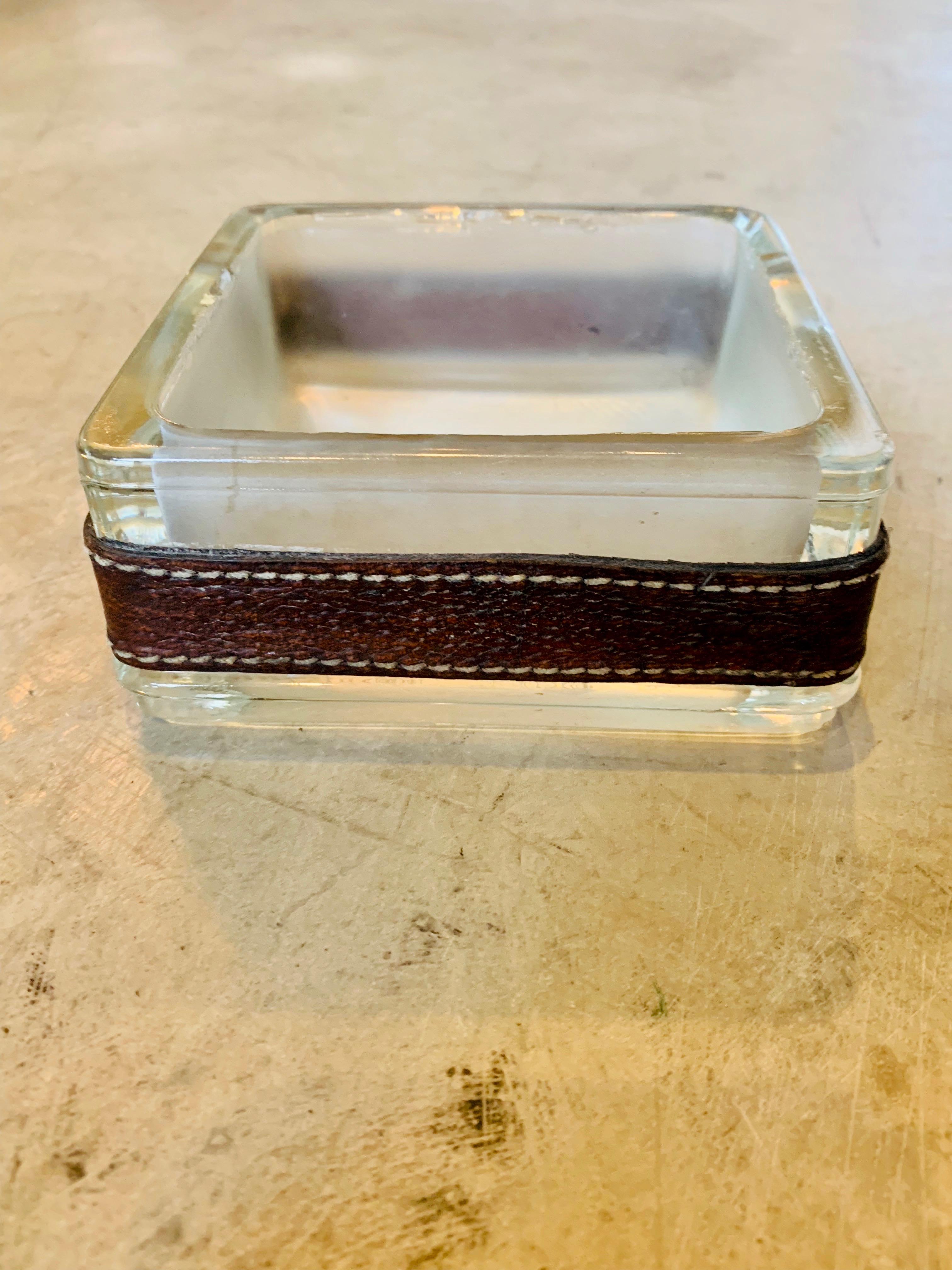 Handsome saddle leather and glass catchall by Jacques Adnet. Perfect for keys. Great for the home or office. Great vintage condition.