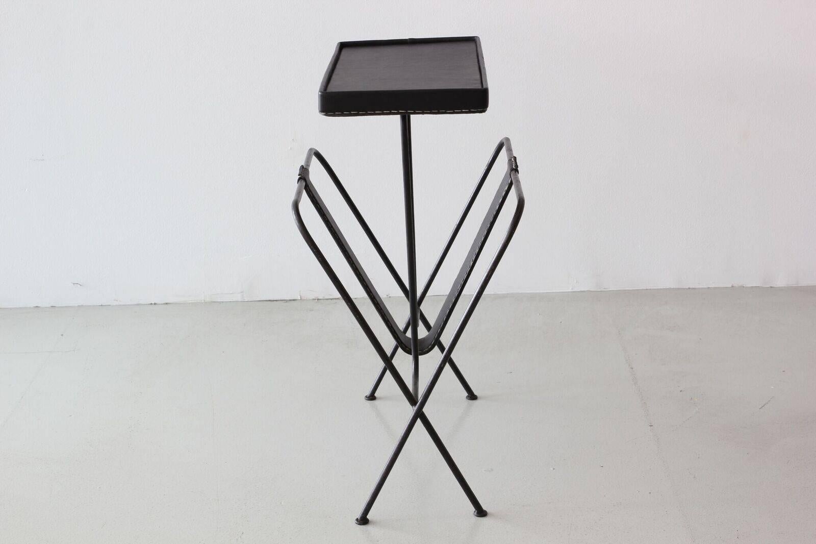 Jacques Adnet side table with magazine holder and newly done signature black leather with contrast stitching.
 