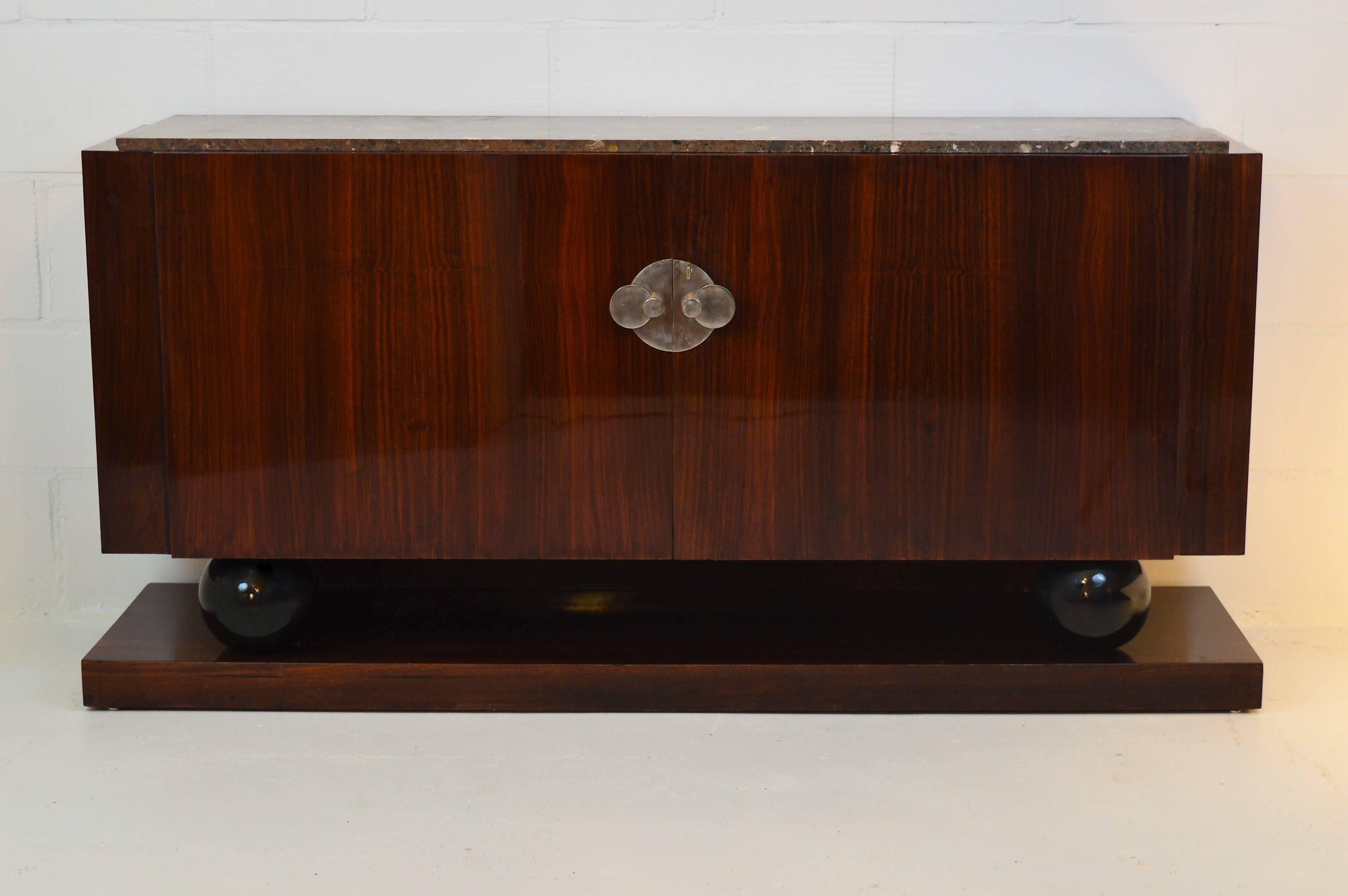 Distinguished sideboard, signed by Jacques Adnet in Indian rosewood and marble top. This sideboard remains in a very good condition.