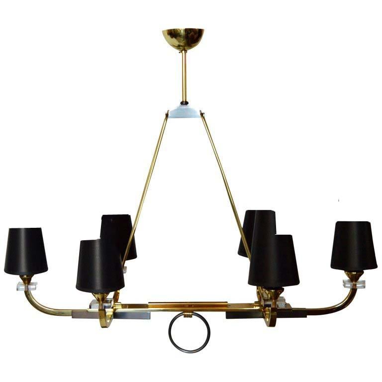 Superbe lustre de Jacques Adnet, deux patines, laiton et métal armé.
Six lampes, 60 watts maximum par lampe.
Câblage américain refait et en état de marche.
La hauteur peut être modifiée sur demande. 
Paire disponible. Prix par paire
Abat-jour : 5