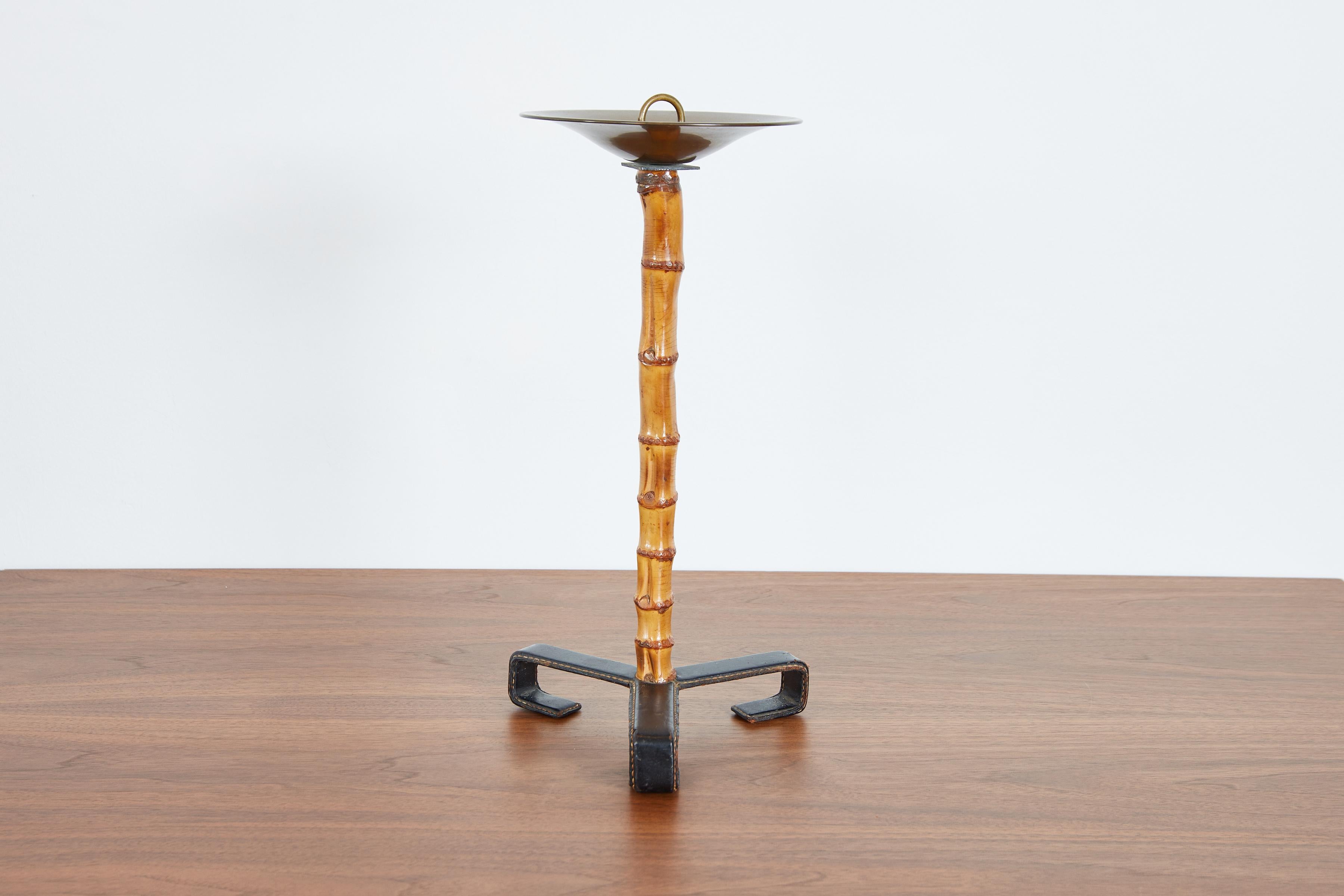 Jacques Adnet standing ashtray with signature black leather tripod base with contrast stitching - bamboo stem with brass catchall - 
France, 1940s