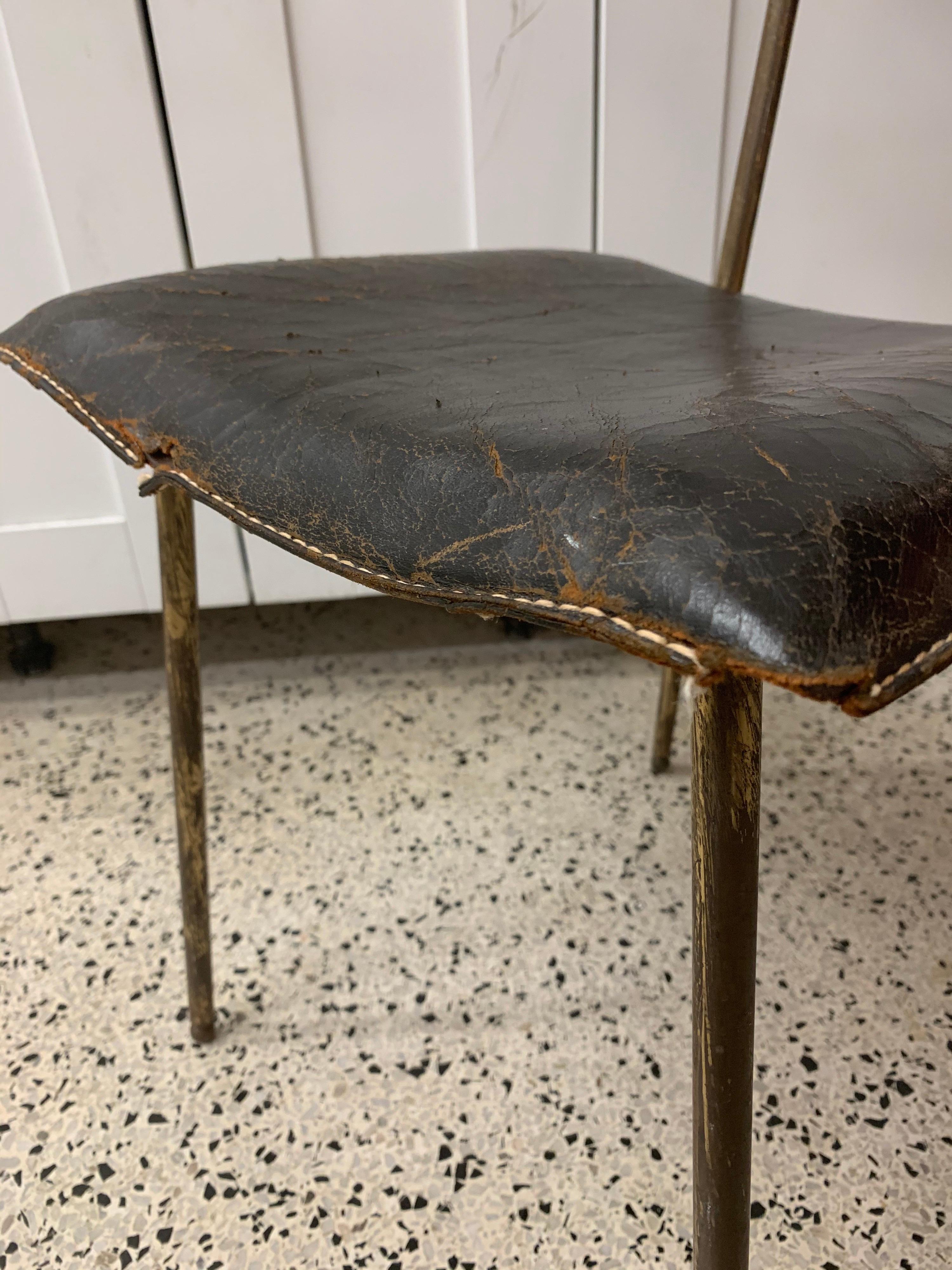 This all original Jacques Adnet stitched black leather side chair on brass structure has all the wonderful aged details of the period. Worn to perfection from regular use, but still very solid.